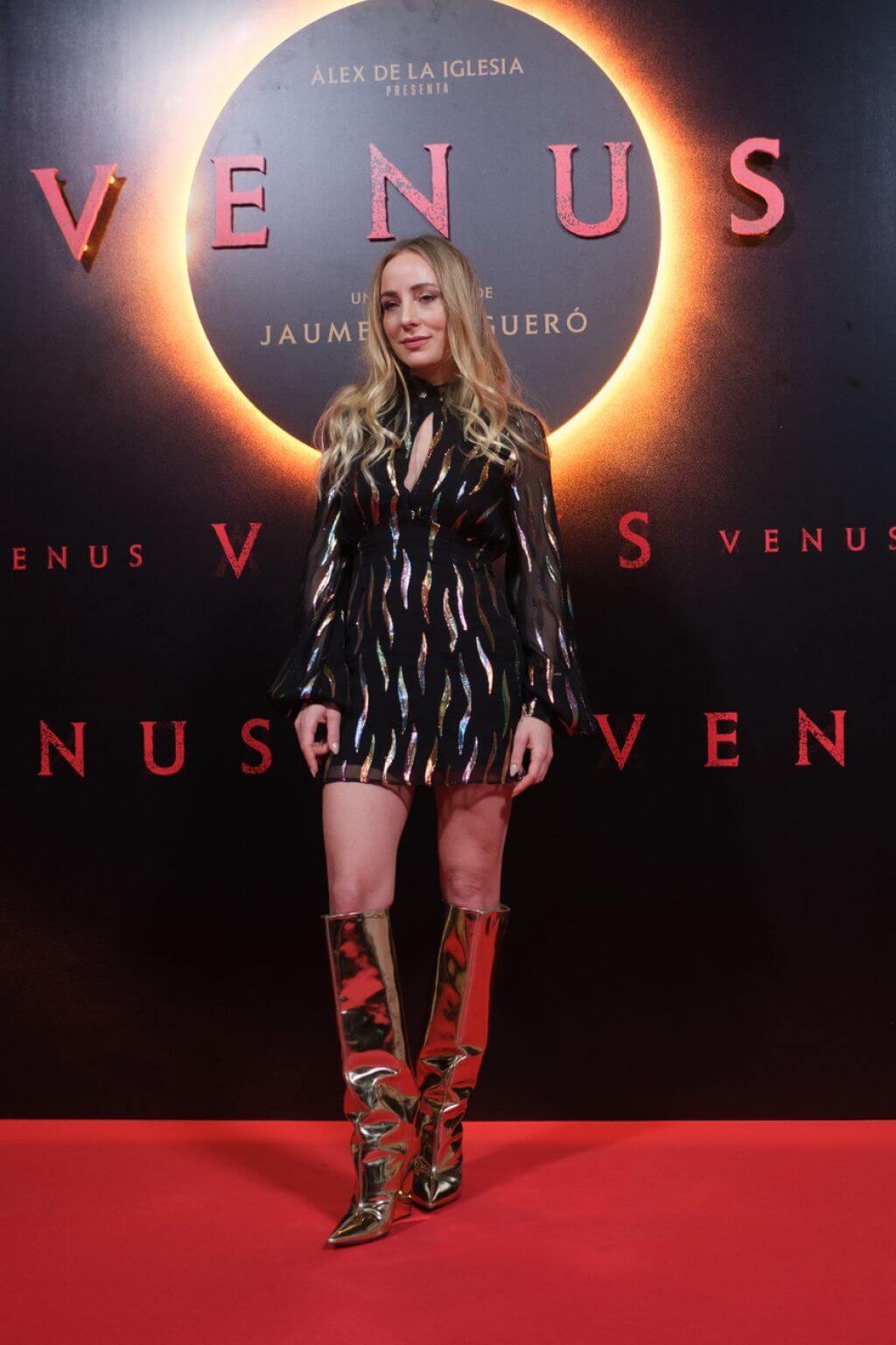 Angela Cremonte In Black Shimmery Printed High Neck Short Dress With Golden Boots At“Venus” Photocall in Madrid