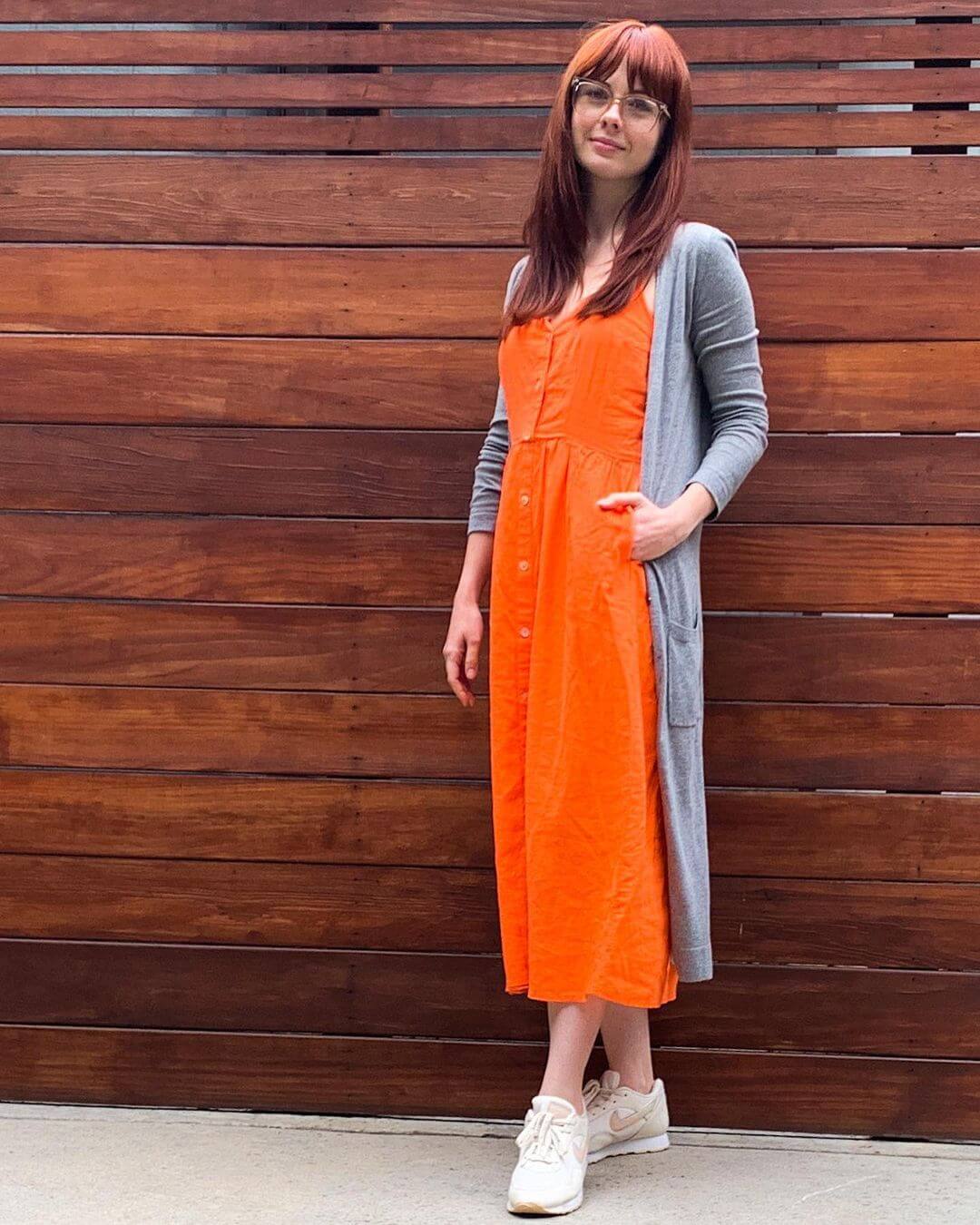 Galadriel Stineman In An Orange Buttoned Long Dress With Grey Long Shrug Outfit