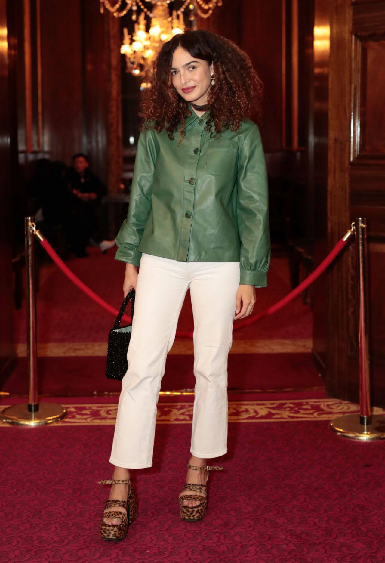 Anna Shaffer In Green Leather Shirt With White Pants At RIXO Presentation In London Fashion Week