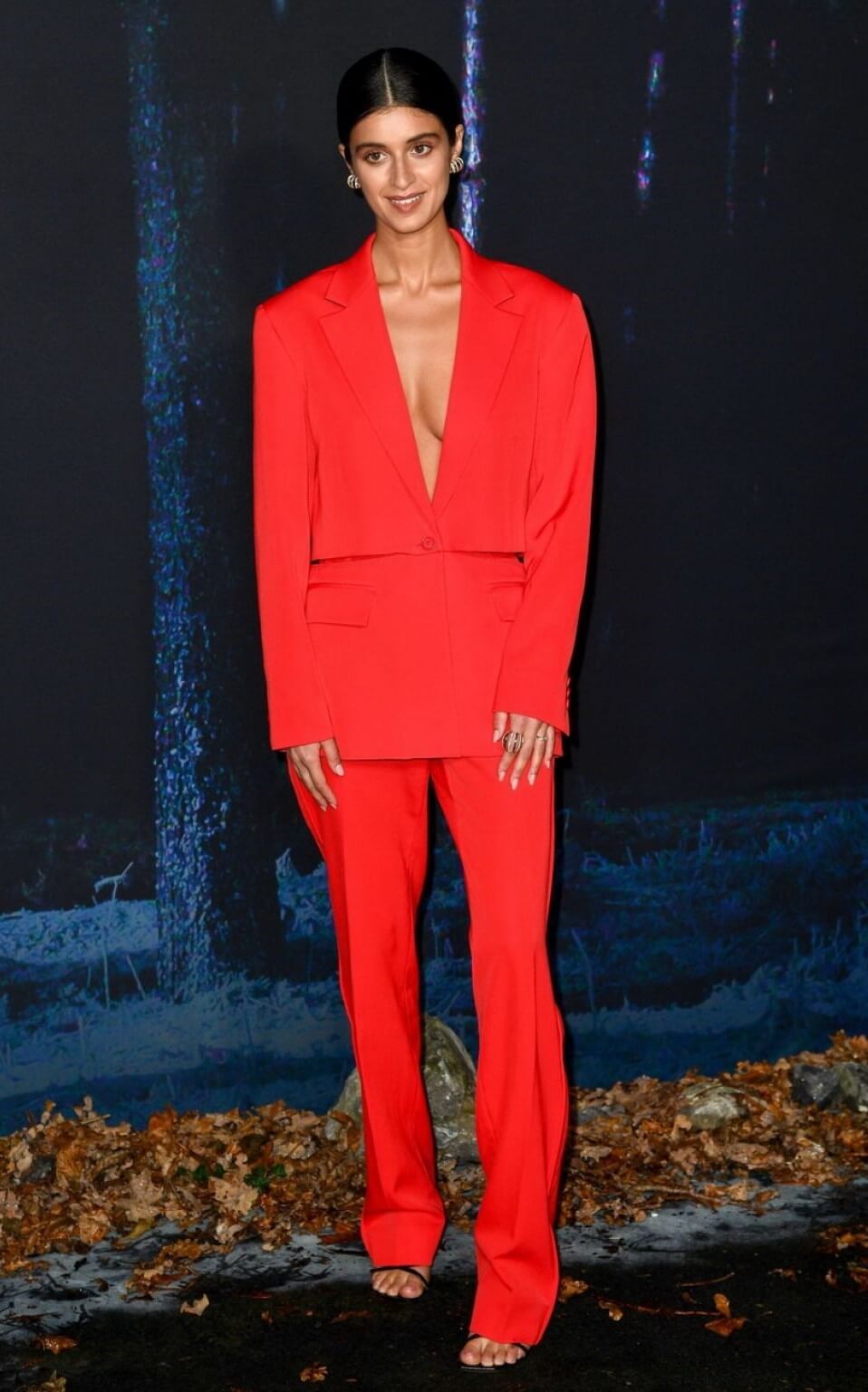 Anya Chalotra In Bright Red Deep Neckline Blazer & Pants At “The Witcher” Season 2 World Premiere in London