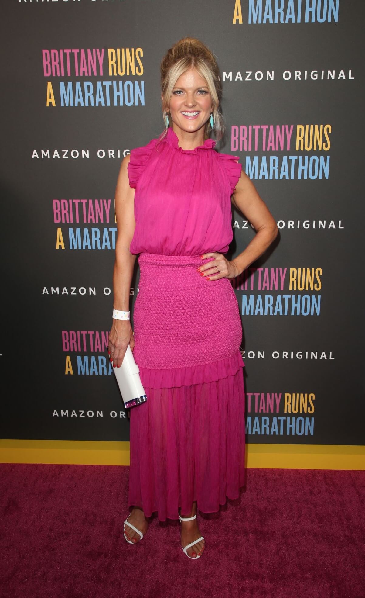 Arden Myrin In Pink Ruffle Long Dress With White Clutch At“Brittany Runs A Marathon” Premiere in LA