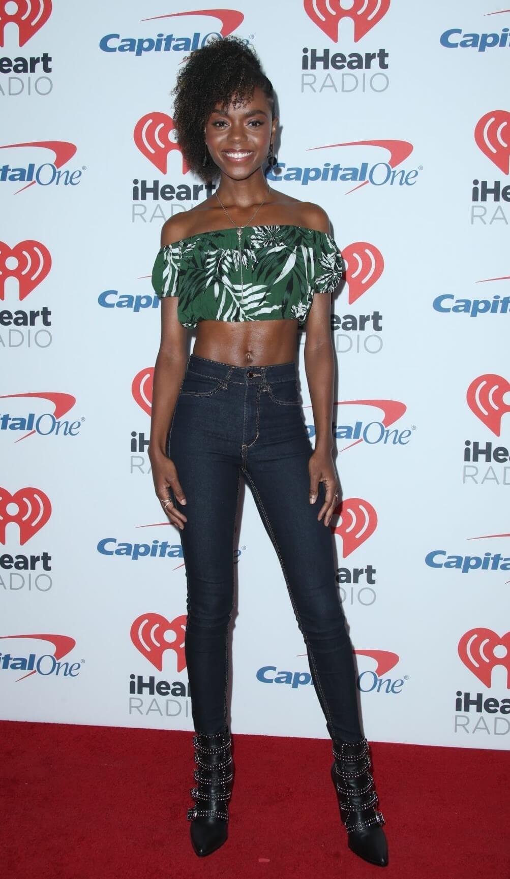 Ashleigh Murray In Green Digital Printed Crop Top With Blue Jeans At iHeartRadio Music Festival in Las Vegas