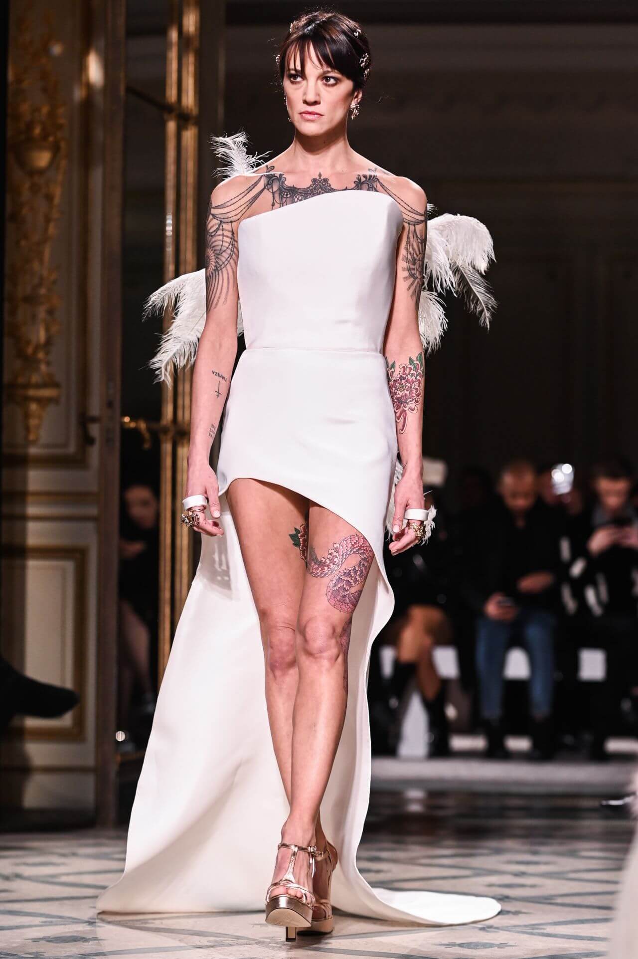 Asia Argento  In White Cut-Out Feather Long Slit Cut Dress At Walks Grimaldi Fashion Show in Paris