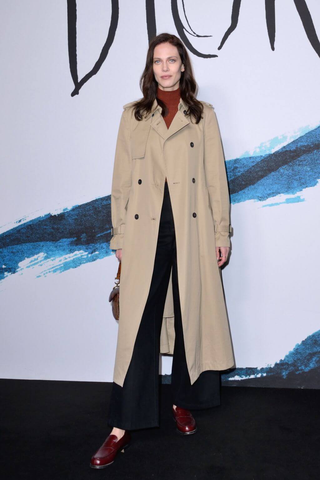 Aymeline ValadeIn Beige Long Overcoat Under High Neck Top & Pants At Dior Homme Menswear Show in Paris