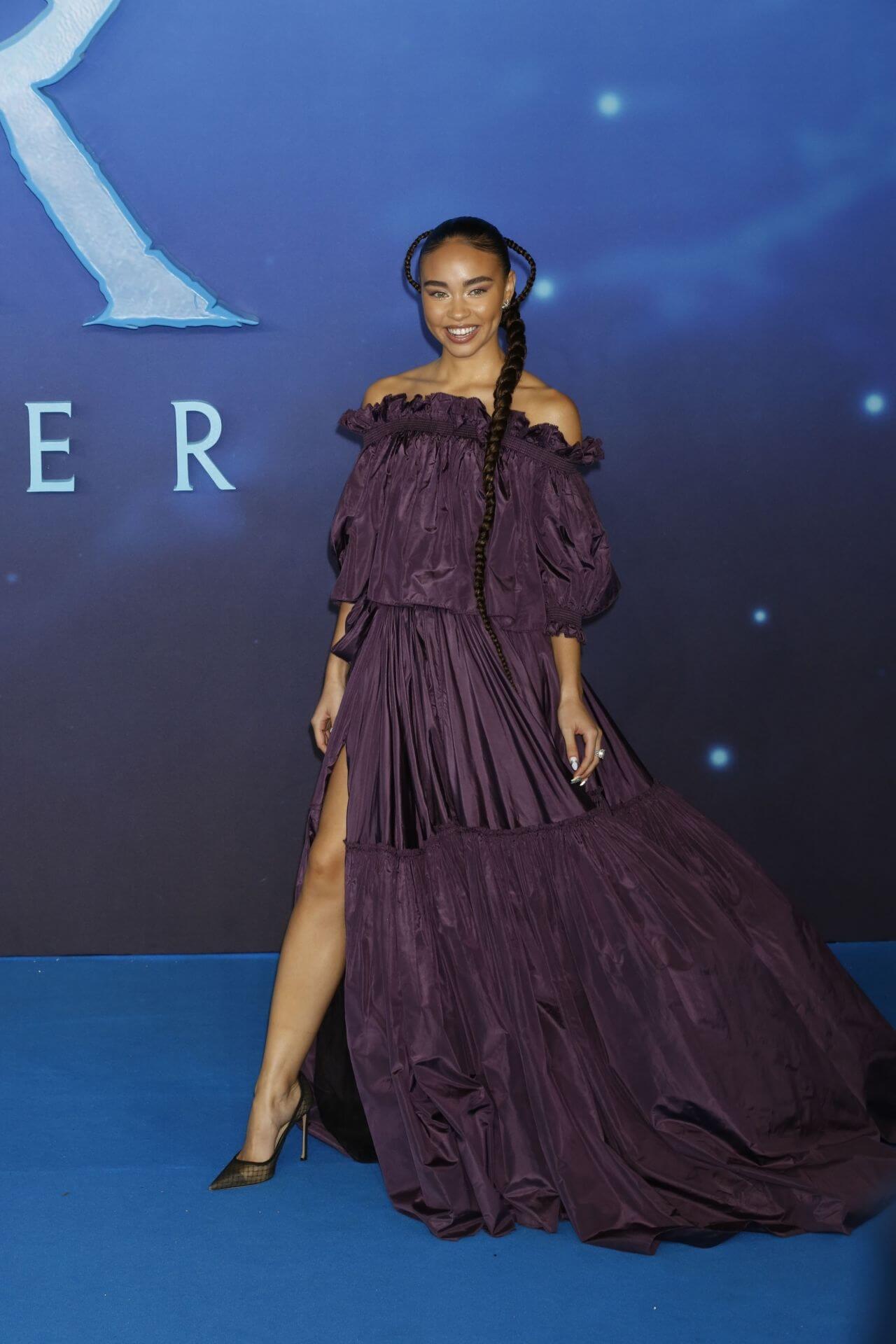 Bailey Bass In Purple Off Shoulder Long Slit Cut Flare Gown At “Avatar: The Way of Water” Premiere in London