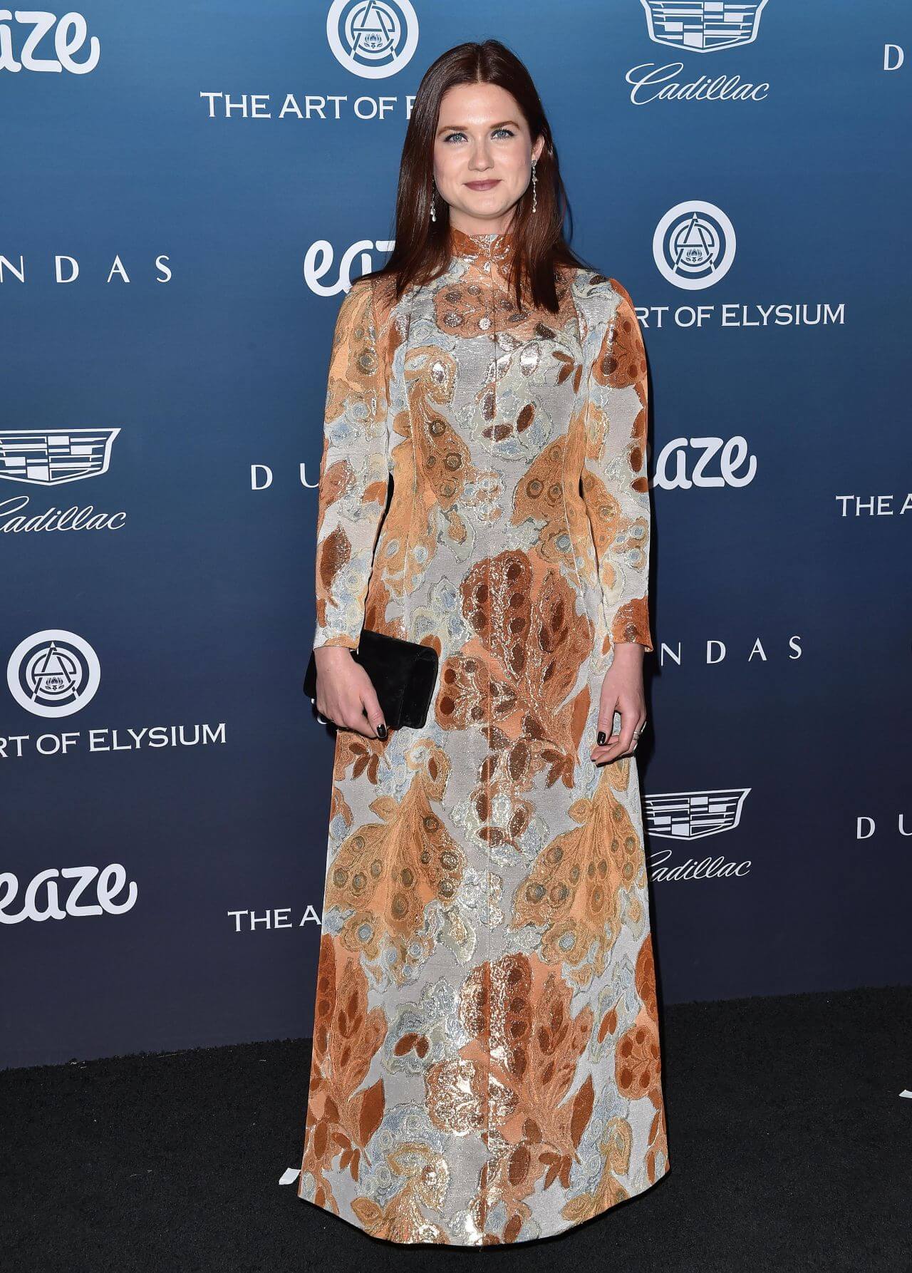 Bonnie Wright  In Orange Shimmery Patchwork Long Maxi Dress At The Art of Elysium’s 12th Annual “Heaven” Gala