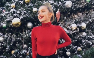 Brady Reiter In Red Full Sleeves High Neck Top With Black Buttoned Mini Skirt Outfit