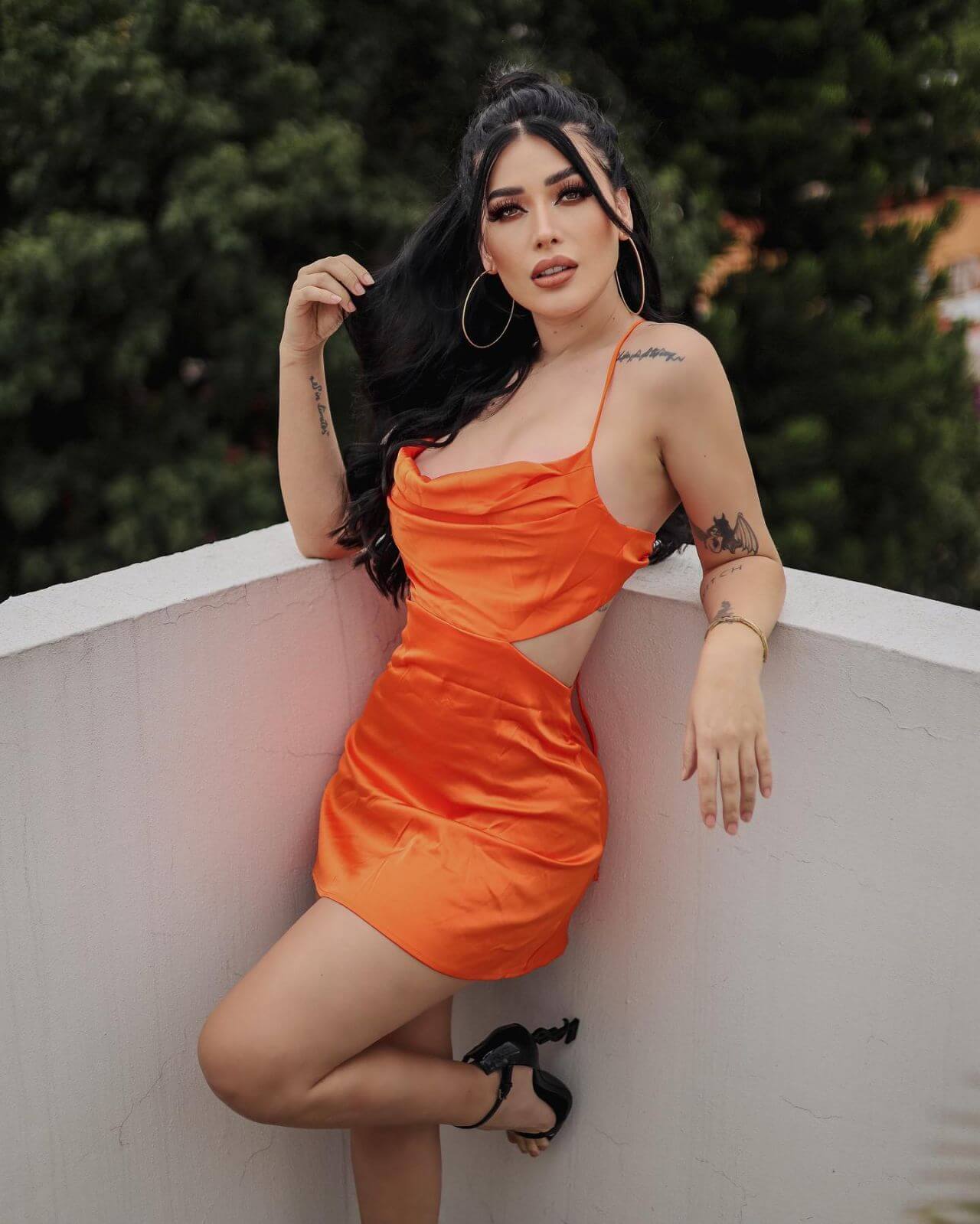 Brenda Zambrano In An Orange Cut Out Strap Sleeves Mini Outfit