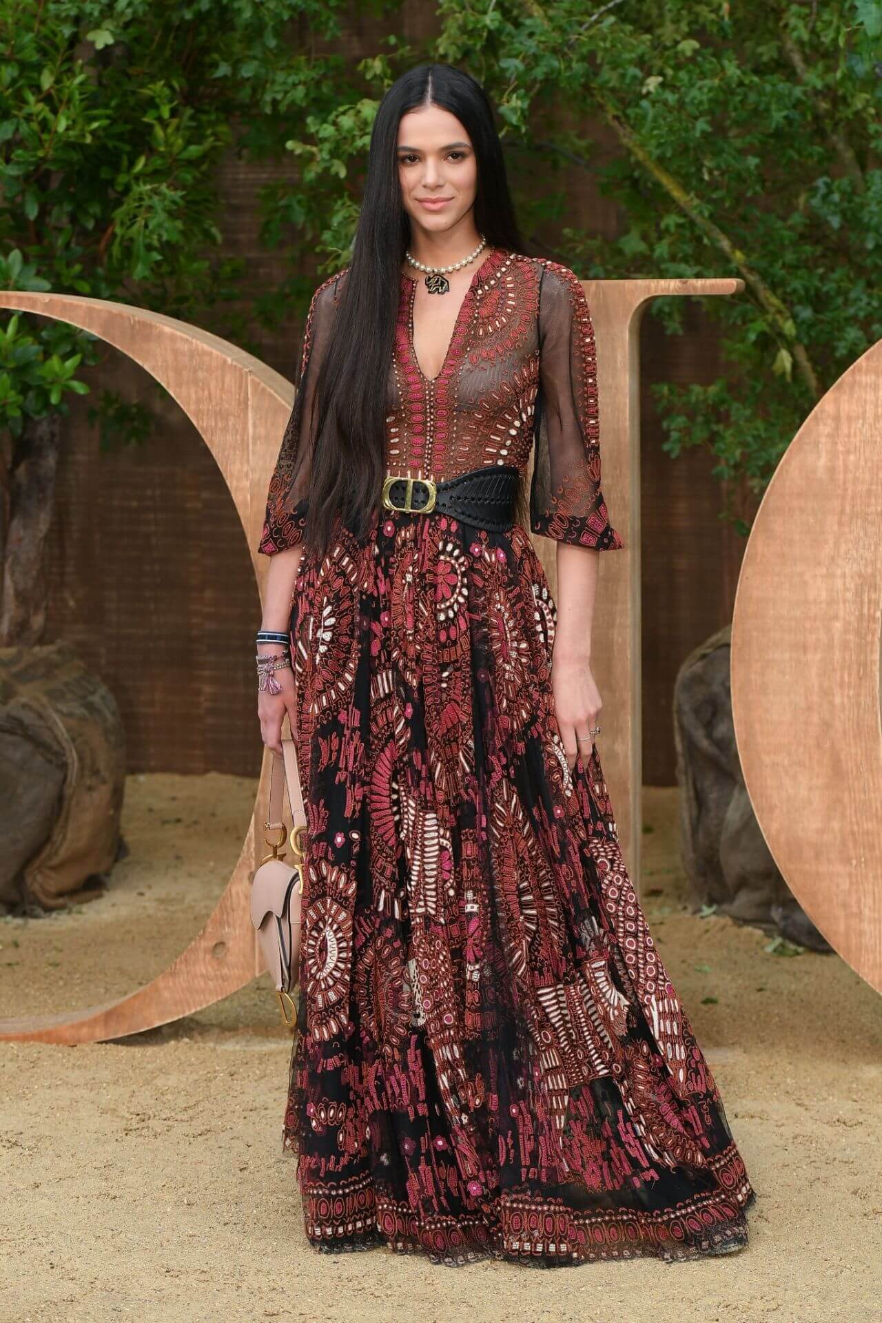 Bruna Marquezine  In Maroon Embroidery Work Full Sleeves Maxi Dress At Christian Dior Fashion Show in Paris