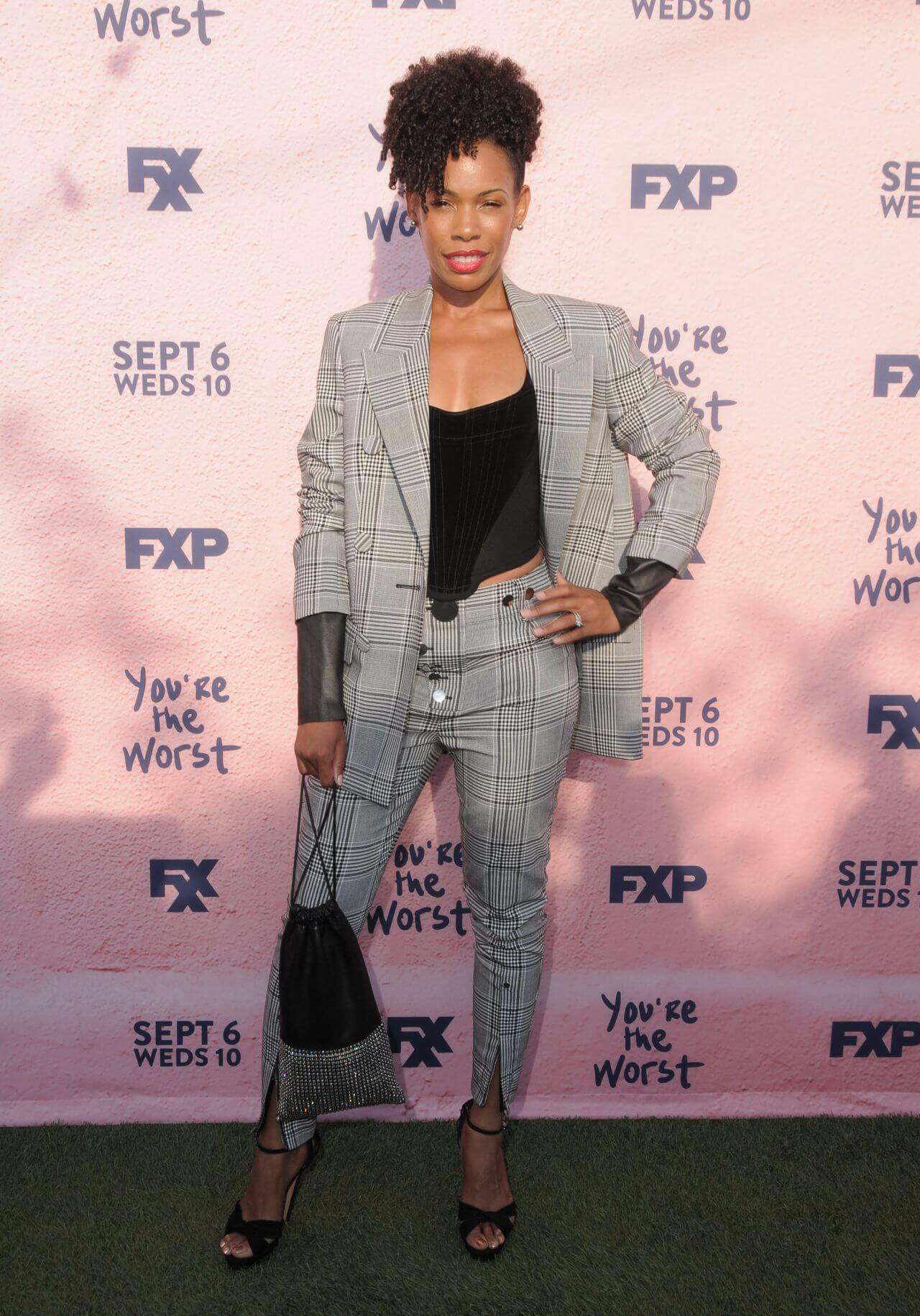 Angela Lewis In Grey Stripped Checks Blazer & Pants With Black Crop Top At“You’re the Worst” TV Show Premiere in Los Angeles