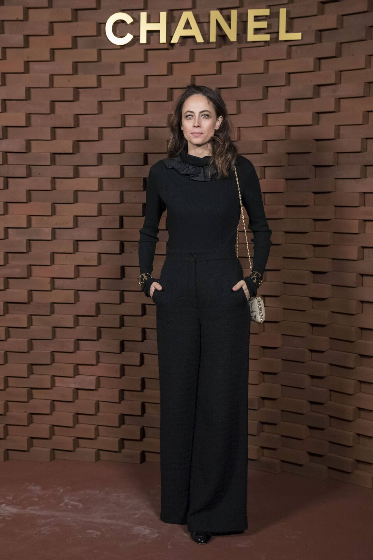 Anne Berest In Black Full Sleeves Ruffle Design Neck Jumpsuit At Chanel Fashion Show in Hamburg