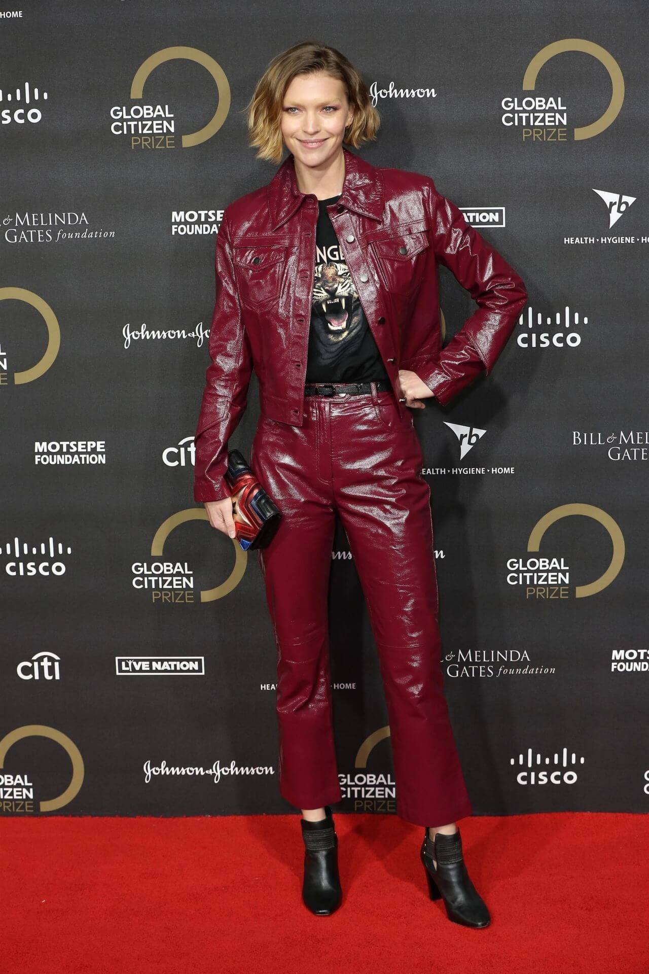 Arizona Muse In Shiny Maroon Leather Jacket & Pants With Black T-shirt At Global Citizen Prize