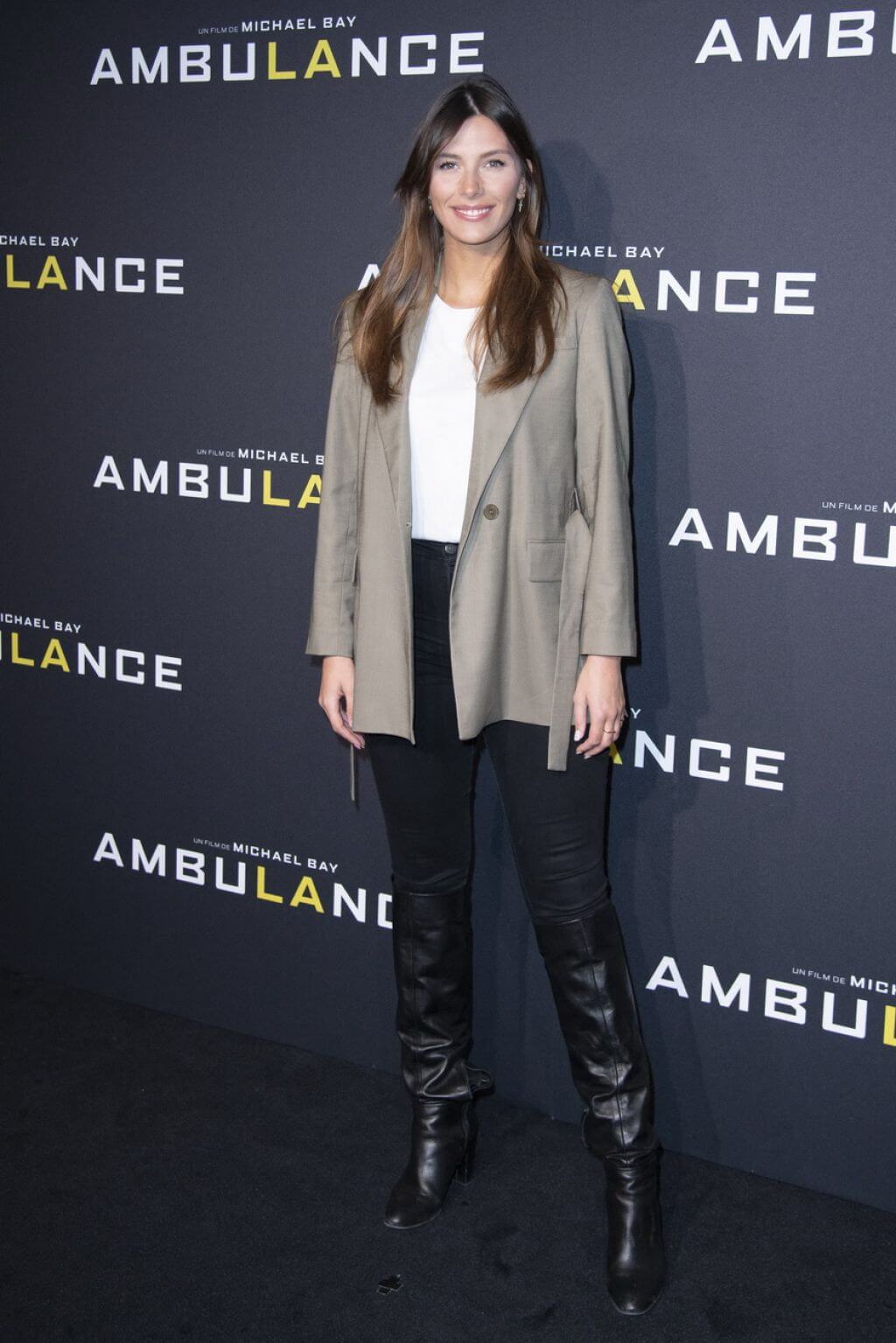 Camille Cerf  In Grey Long Blazer Under White Top With Black Jeans At “Ambulance” Premiere in Paris