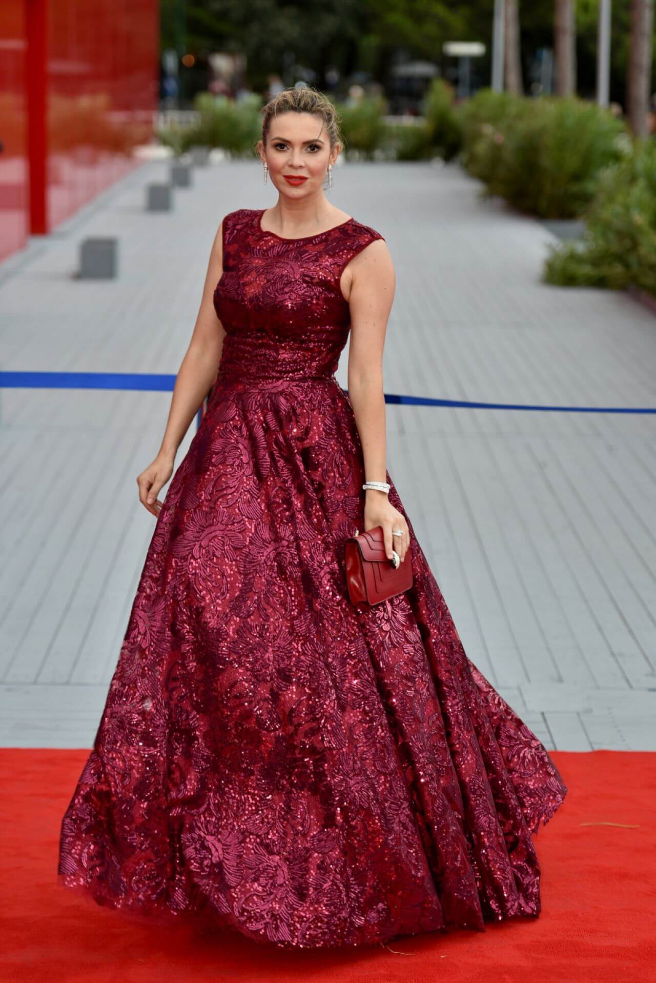 Carly Steel  In Maroon Shimmery Sleeveless Long Flare Gown At The Franca Sozzani Award in Venice, Italy