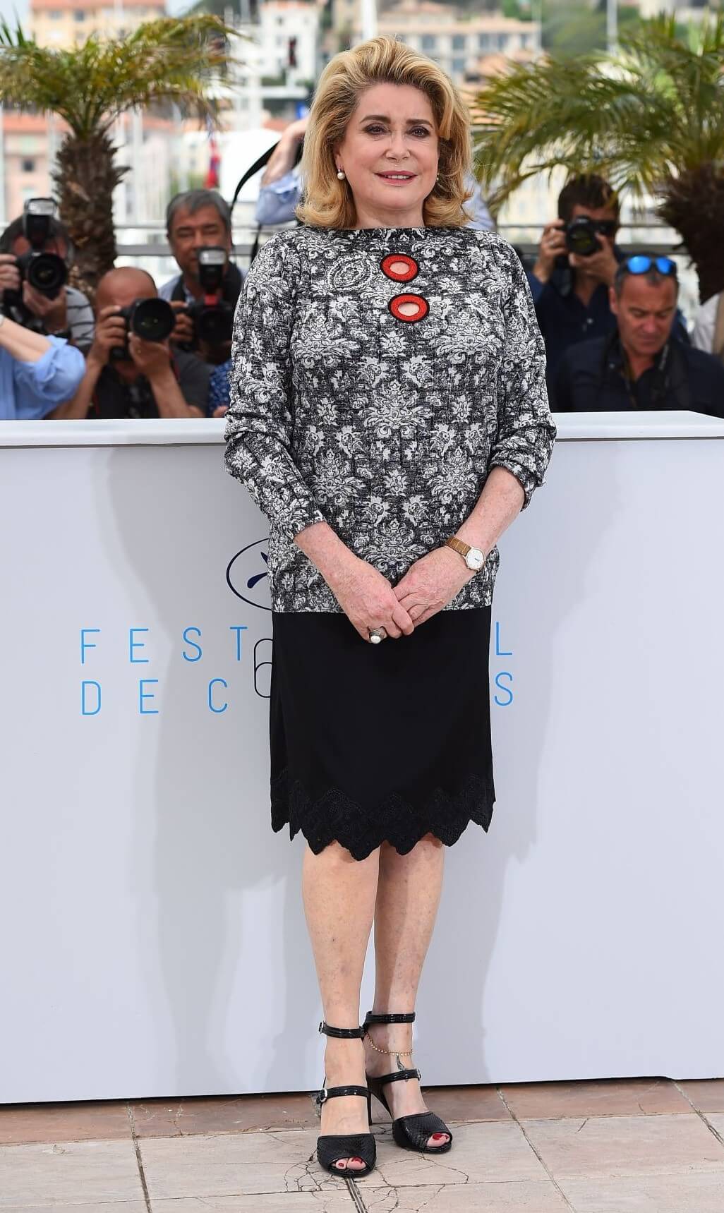 Catherine Deneuve In  Grey Embroidery Full Sleeves Top With Black Short Skirt At  Photocall for ‘La Tete Haute’ Cannes Film Festival