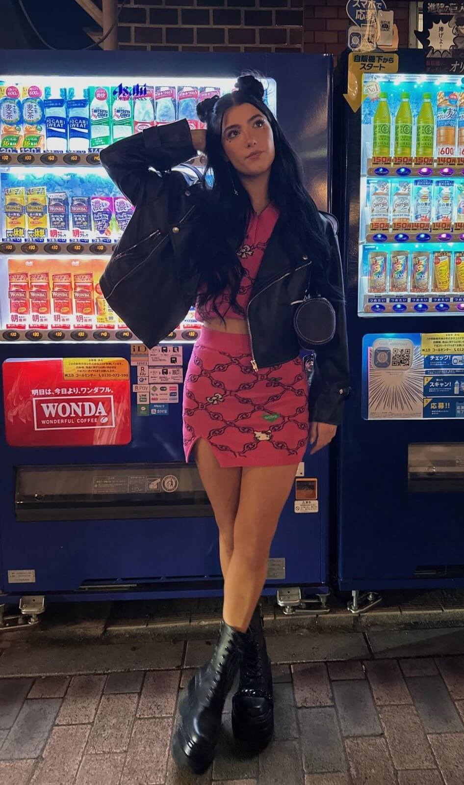 Charli D’Amelio In Black Leather Jacket With Pink Crop Top & Mini Skirt At Kids Choice Awards in Los Angeles