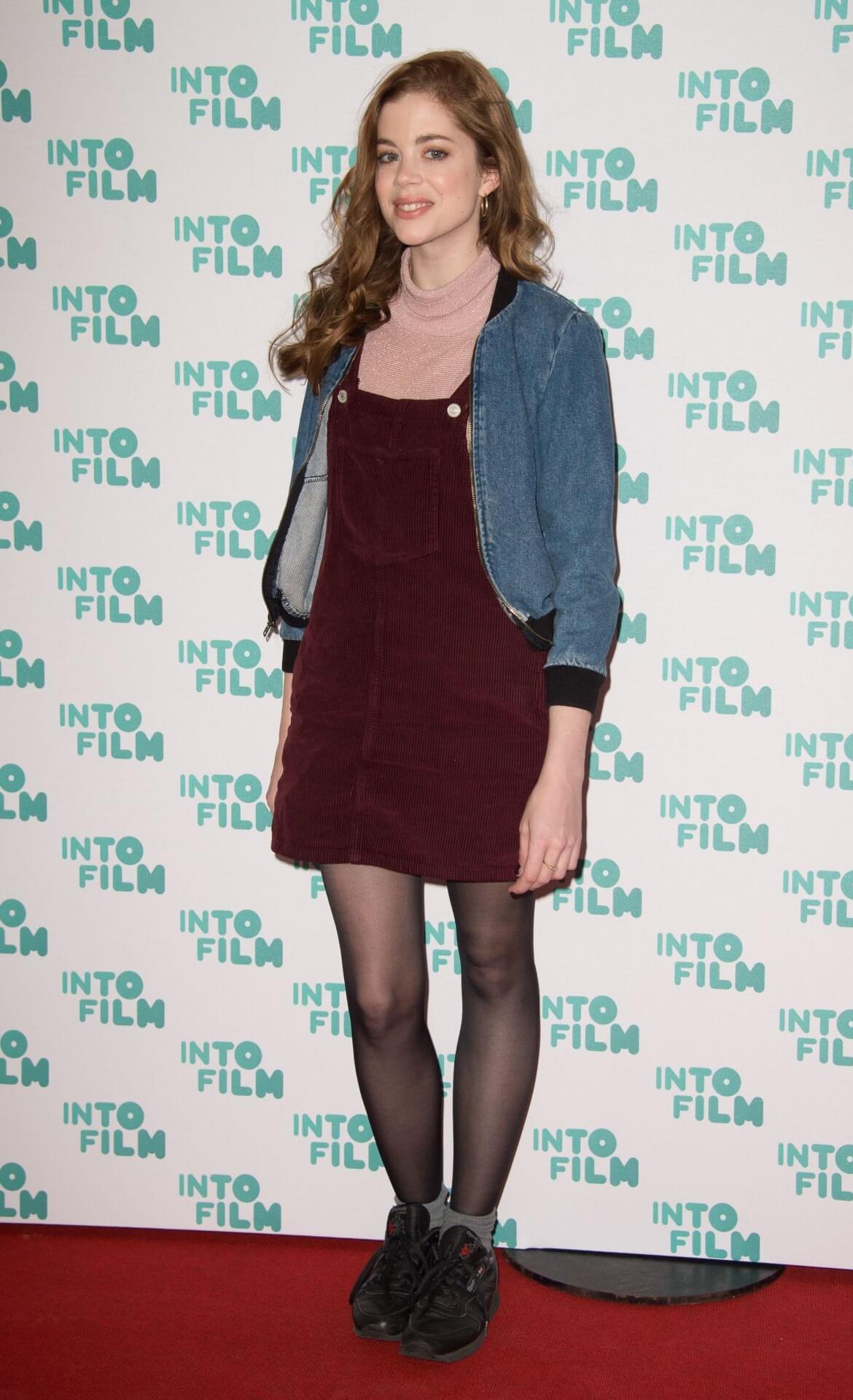 Charlotte Hope In Blue Denim Jacket With Maroon High Rise Short Dress At Into Film Awards in London, UK
