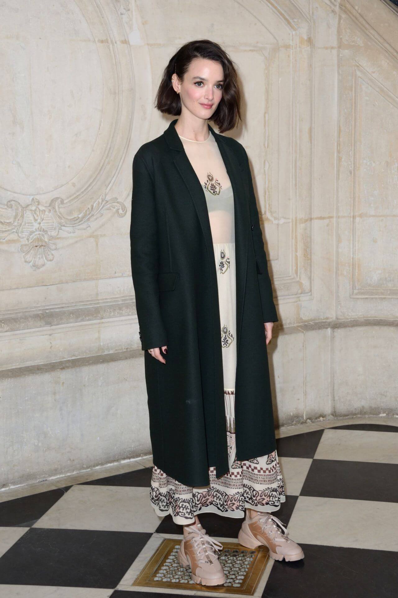 Charlotte Le Bon In Black Long Overcoat Under Printed Long Dress At Christian Dior Fashion Show in Paris