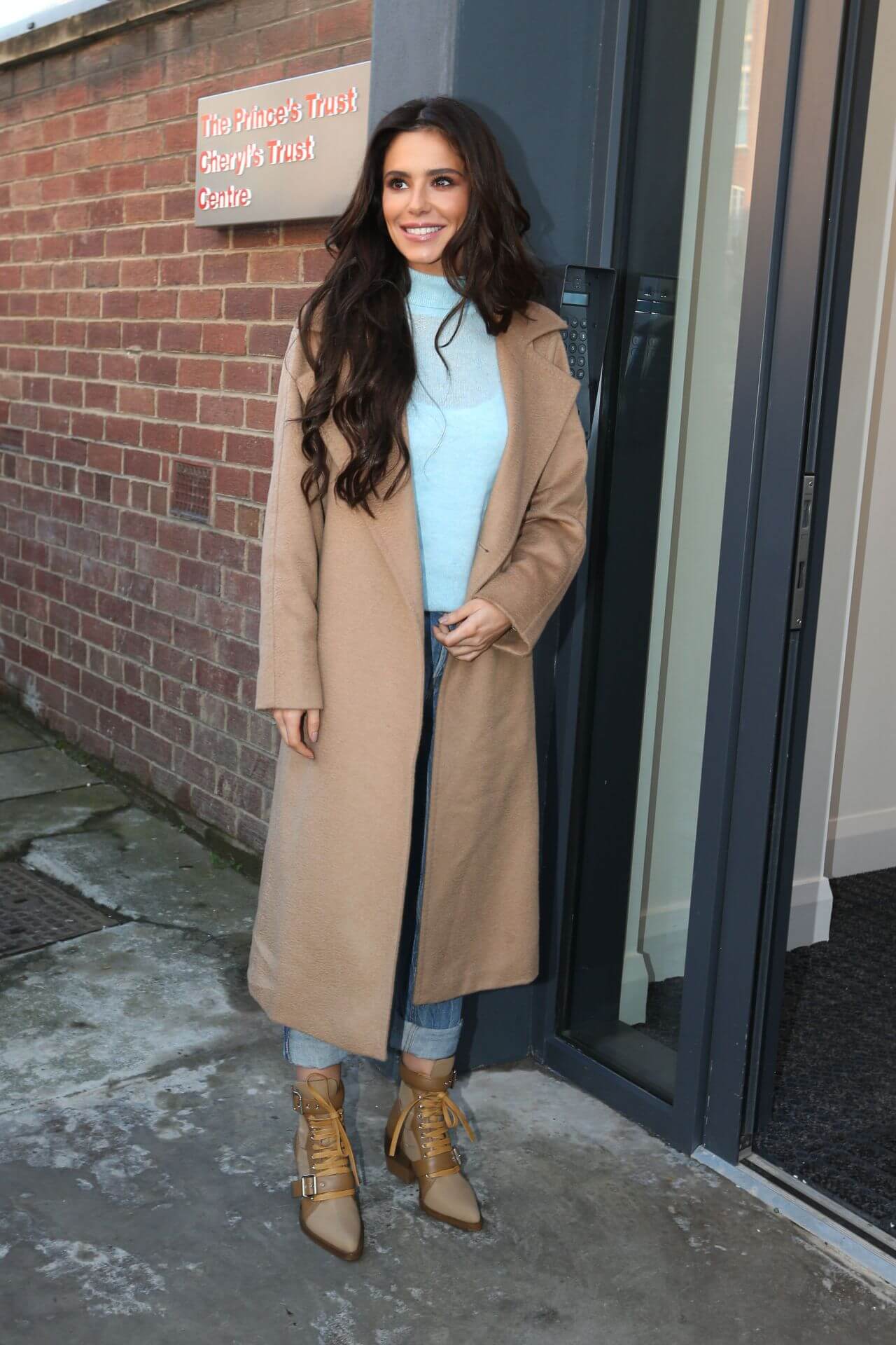 Cheryl Cole In Beige Long Overcoat Under Blue Top & Jeans  Arriving at The Prince’s Trust Cheryl’s Trust in Newcastle