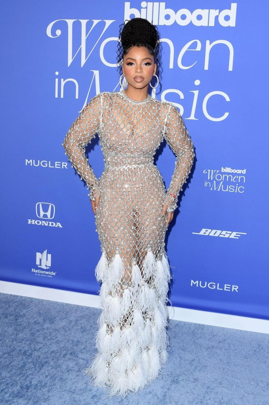 Chloe Bailey In Silver Shimmery With Feather Style Long Gown At Billboard Women in Music Awards in Los Angeles