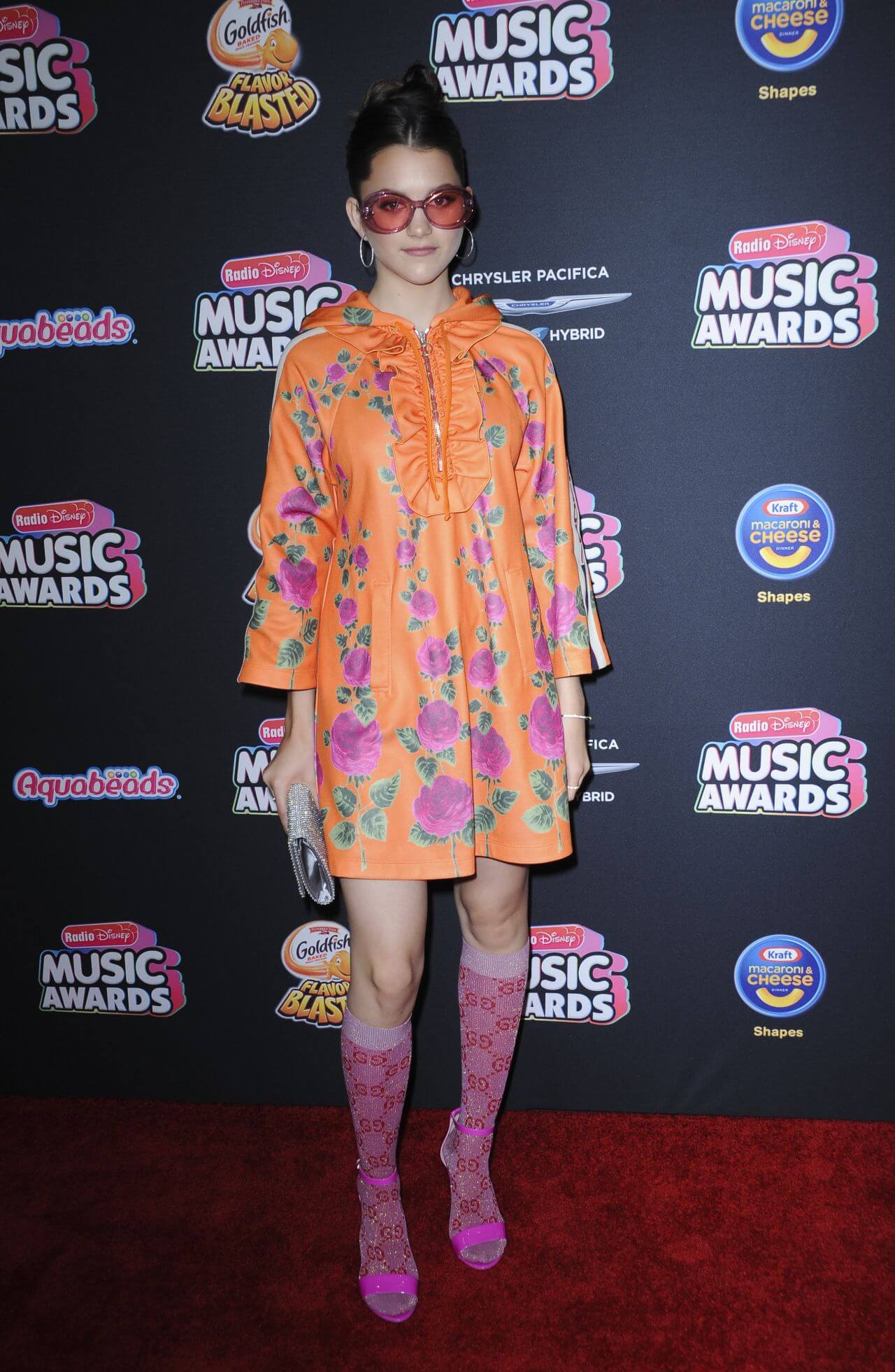 Chloe East In An Orange Floral Print Short Dress At Radio Disney Music Awards in LA