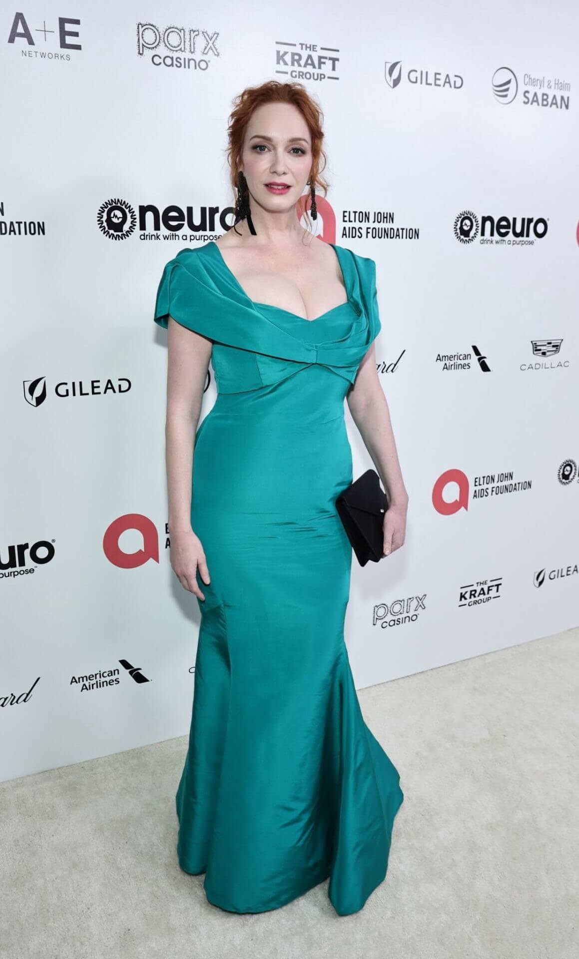 Christina Hendricks In Sea Green Long Flare Gown At Elton John AIDS Foundation’s Oscars  Viewing Party