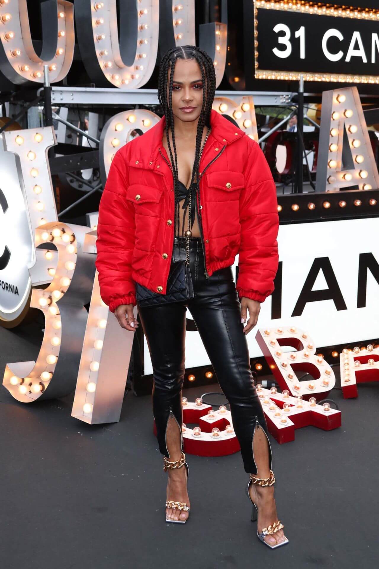 Christina Milian  In Red Bomber Jacket Under Bralette With Black Leather Pants At Chanel Cruise Fashion Show in Los Angeles