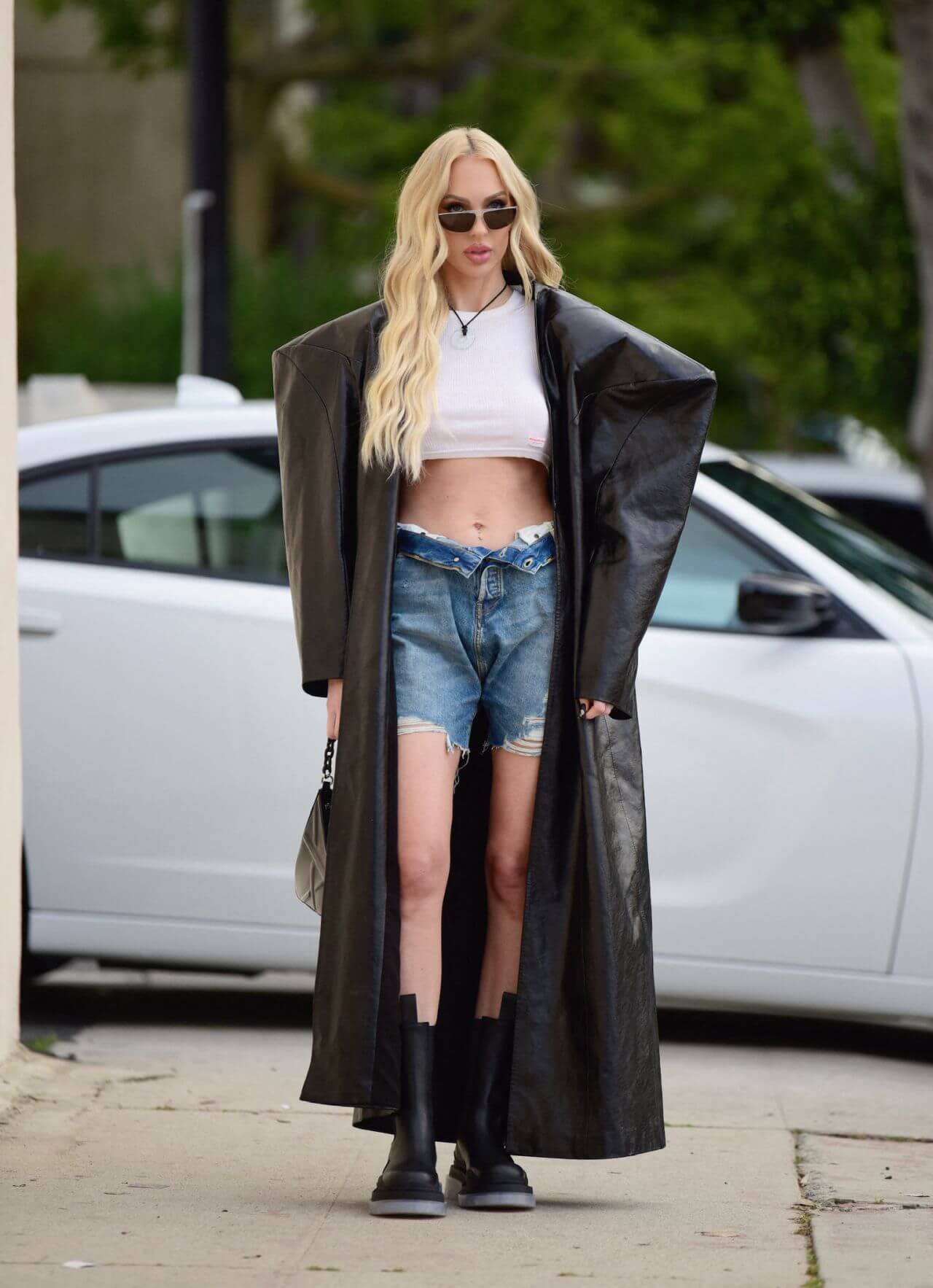 Christine Quinn In Black Leather Baggy Long Overcoat With Denim Shorts