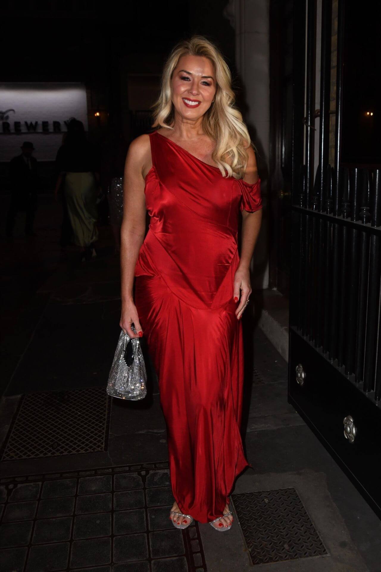 Claire Sweeney  In Shiny Red Asymmetrical Sleeves Long Dress At Together For Short Lives Ball in London