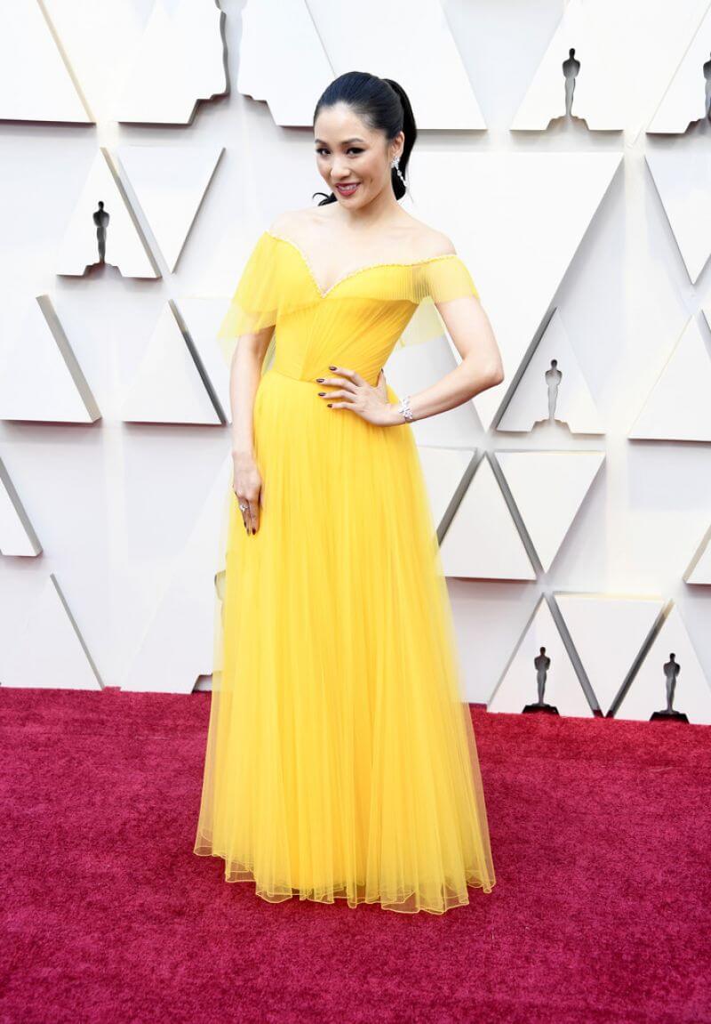 Constance Wu  In Yellow Net Fabric Off-Shoulder Long Gown Dress At Oscars  Red Carpet