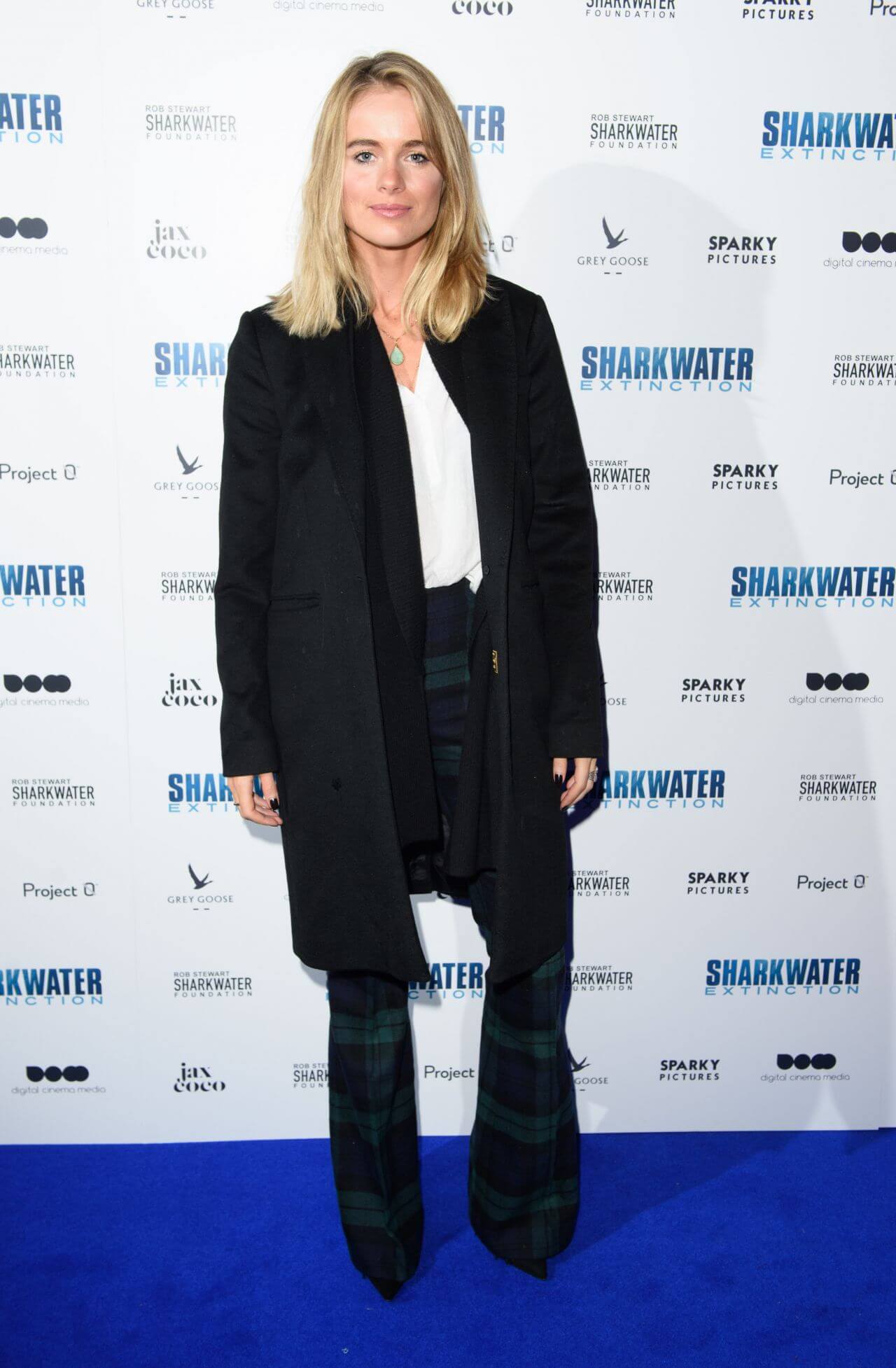Cressida Bonas  In Black Long Coat Under White Top With Checked Pants At “Sharkwater Extinction” Premiere in London