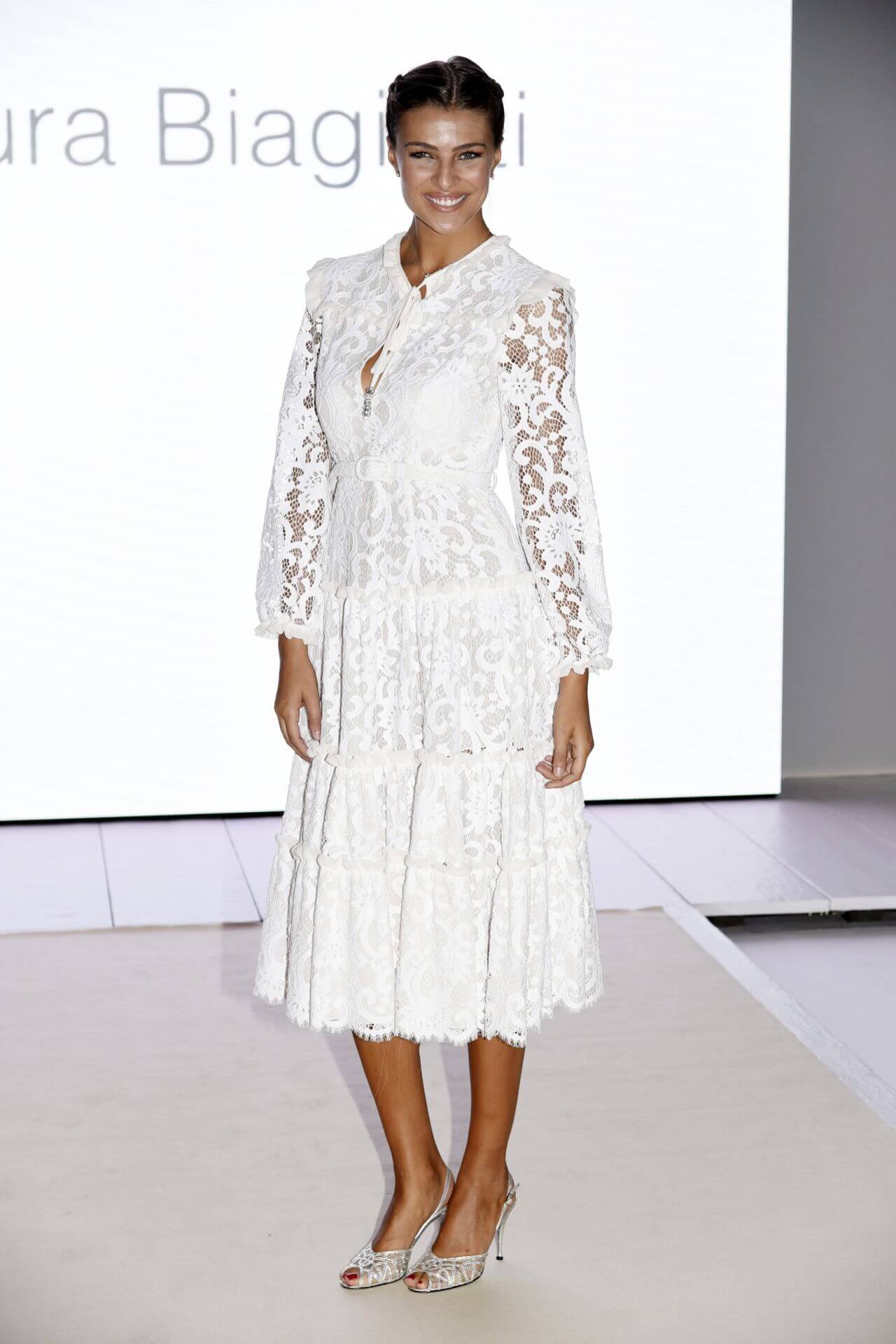 Cristina Chiabotto  In White Lace Design Full Sleeves Layered Gown Dress At Laura Biagiotti Show in Milan