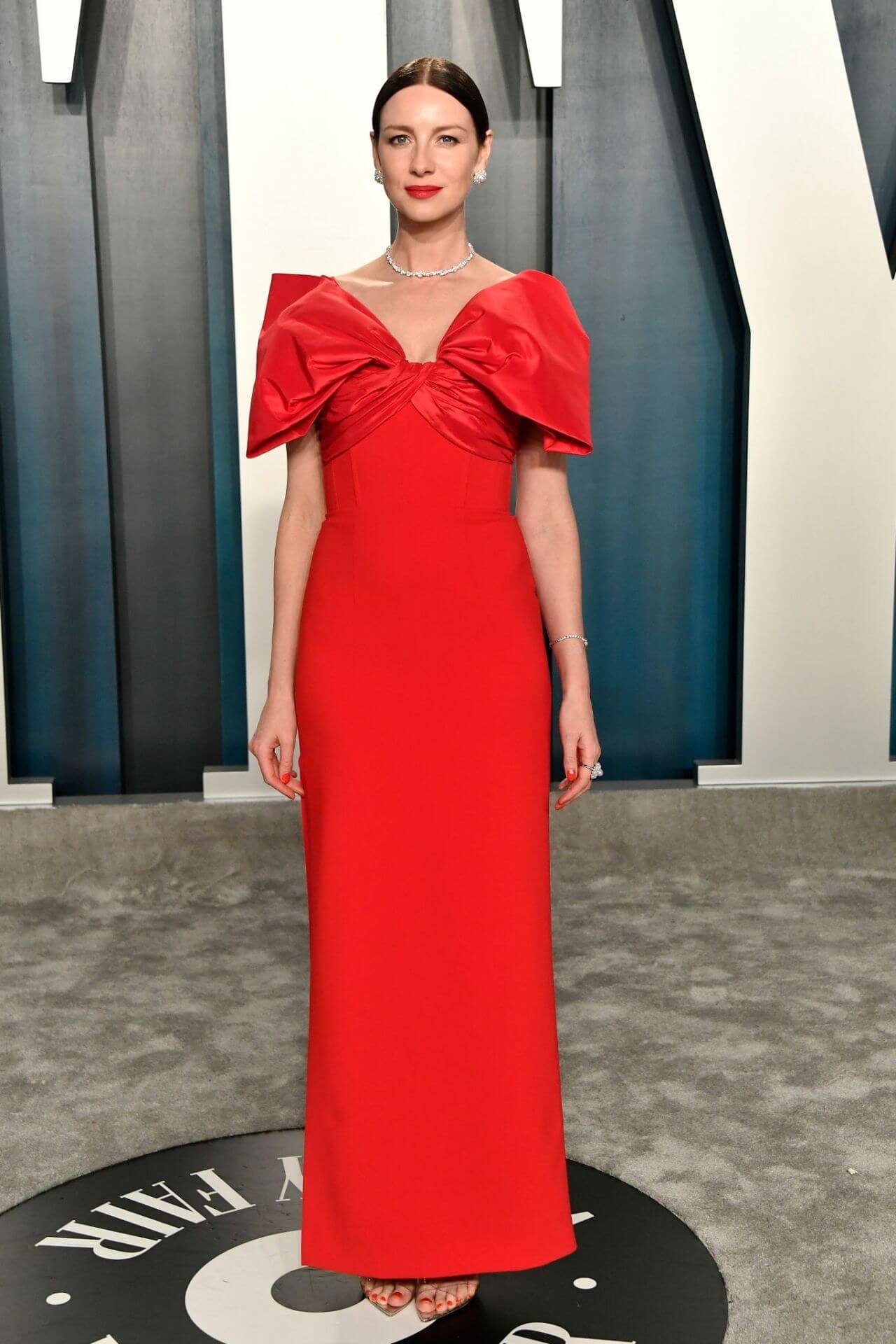 Caitriona Balfe Glossy Looks In Red With Bow Style Long Dress At Vanity Fair Oscar Party