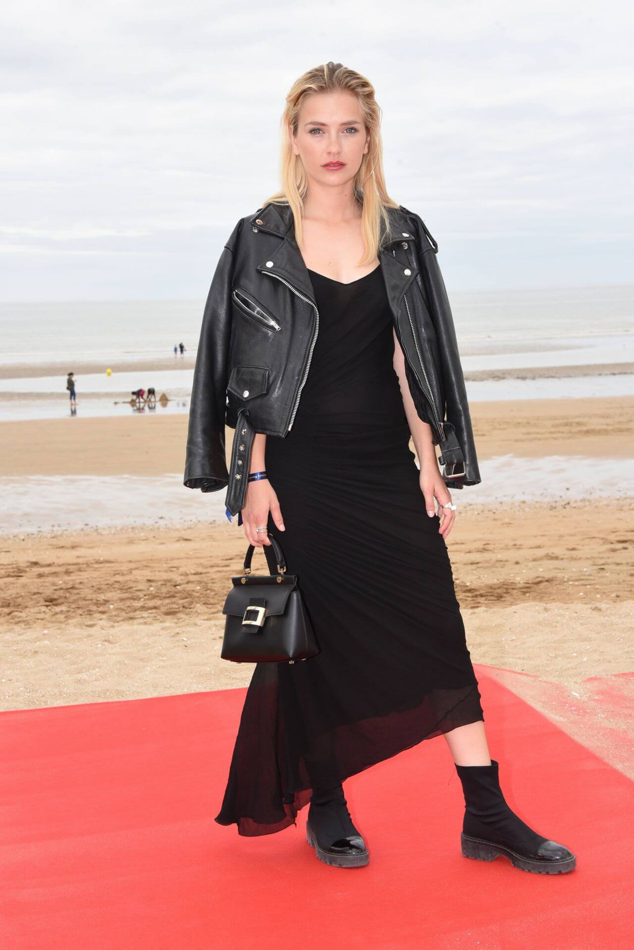 Camille Razat  In Black Sheering Long Dress With Leather Jacket At “Roulez Jeunesse” Photocall at Cabourg Film Festival