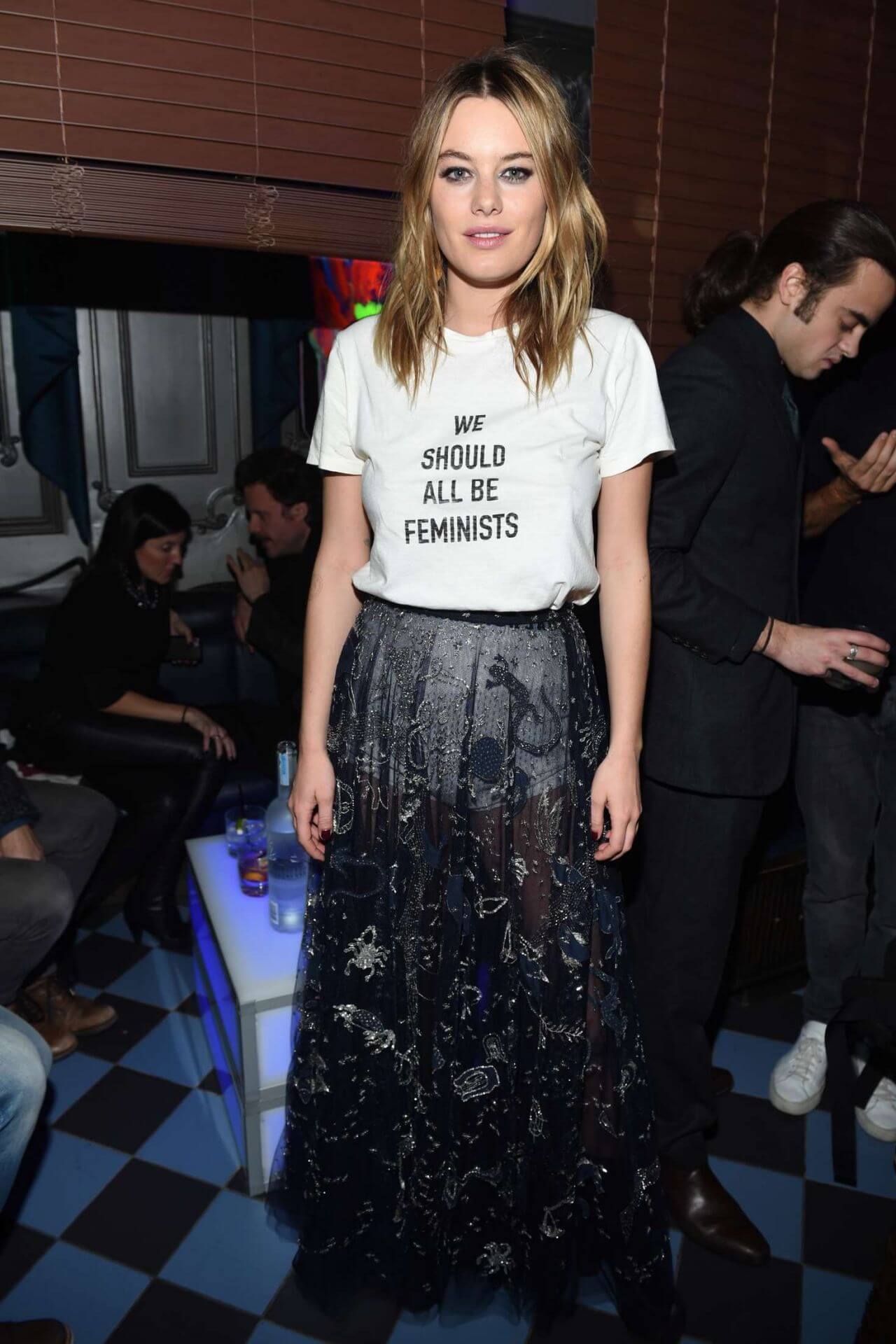 Camille Rowe  In White T-shirt With Shimmery Transparent Skirt Outfit At Dior Celebrates ‘Poison Girl’ in NYC
