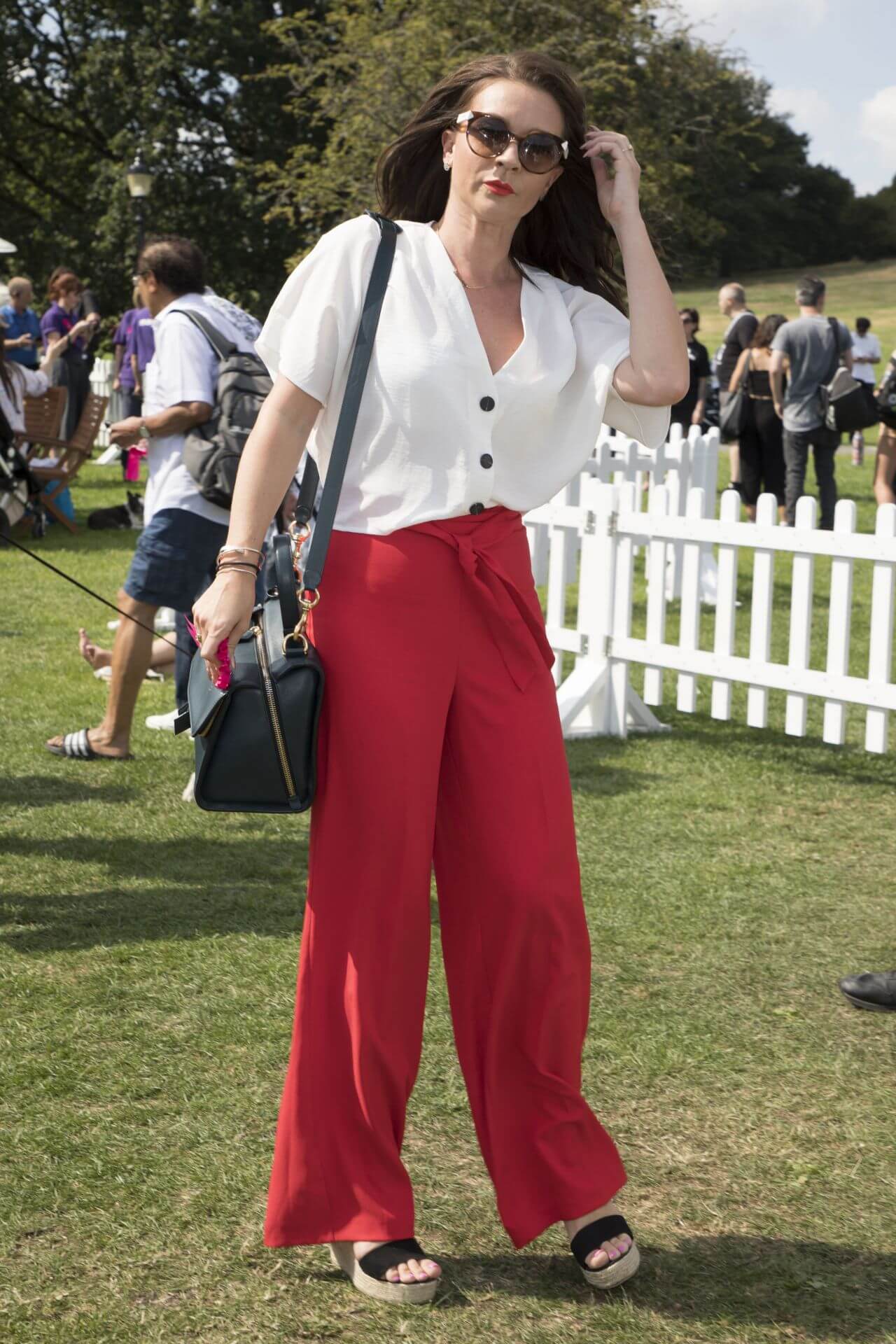 Candice Brown  In White Top With Red Pants At PupAid Event in London