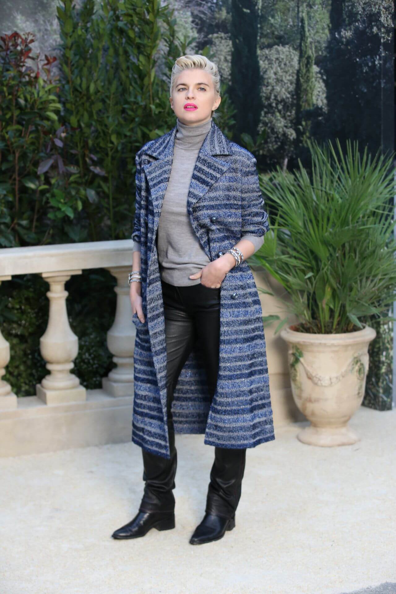 Cecile Cassel  In Blue Striped Long Overcoat Under Grey High Neck Top With Leather Pants At Chanel Show in Paris