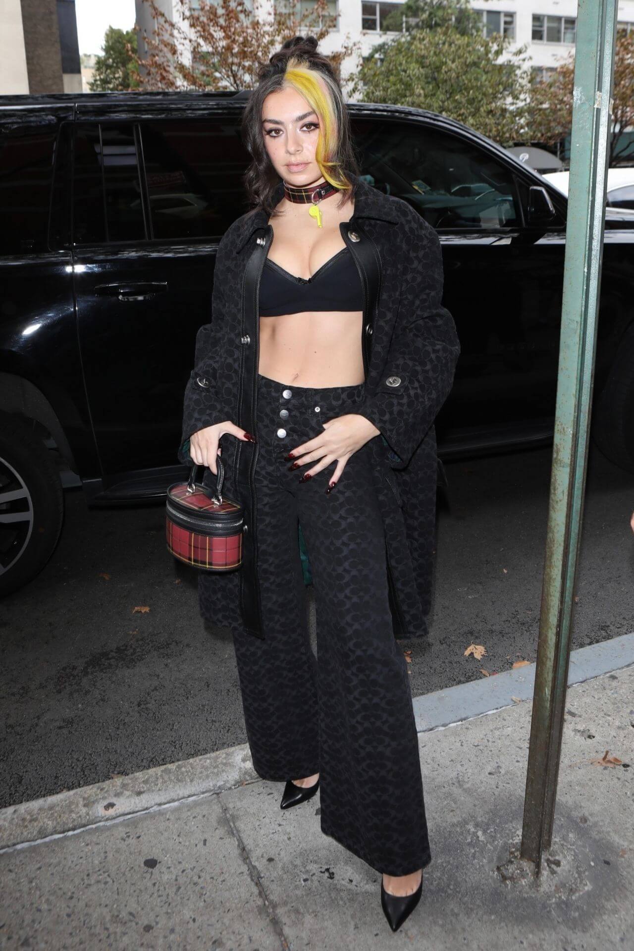 Charli XCX In Black Long Jacket Under Bralette With pants At Coach Fashion Show in New York