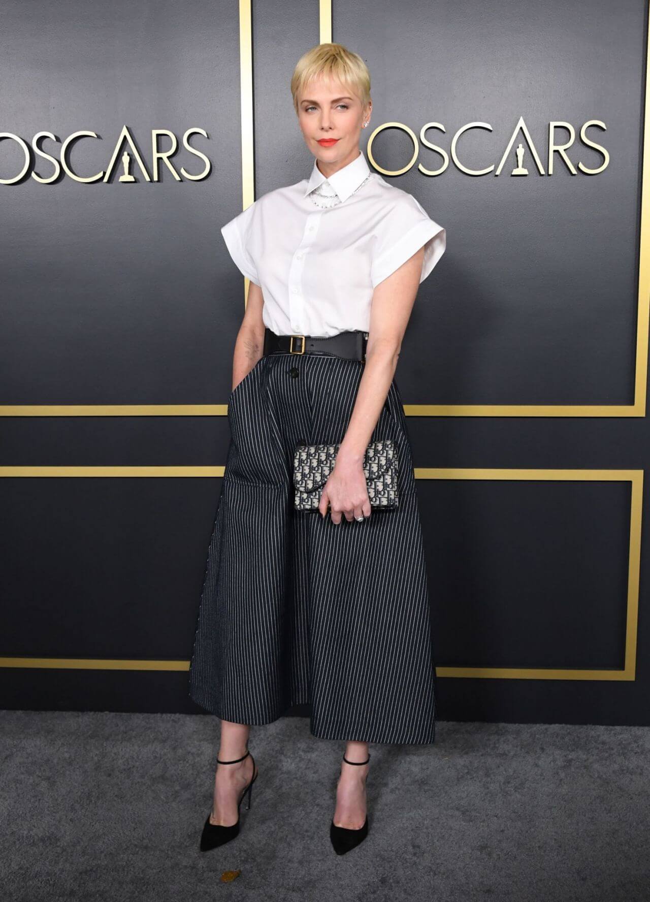 Charlize Theron  In a White Half Sleeves Collar Shirt With Black Striped Flare Pants At Oscars Nominees Luncheon