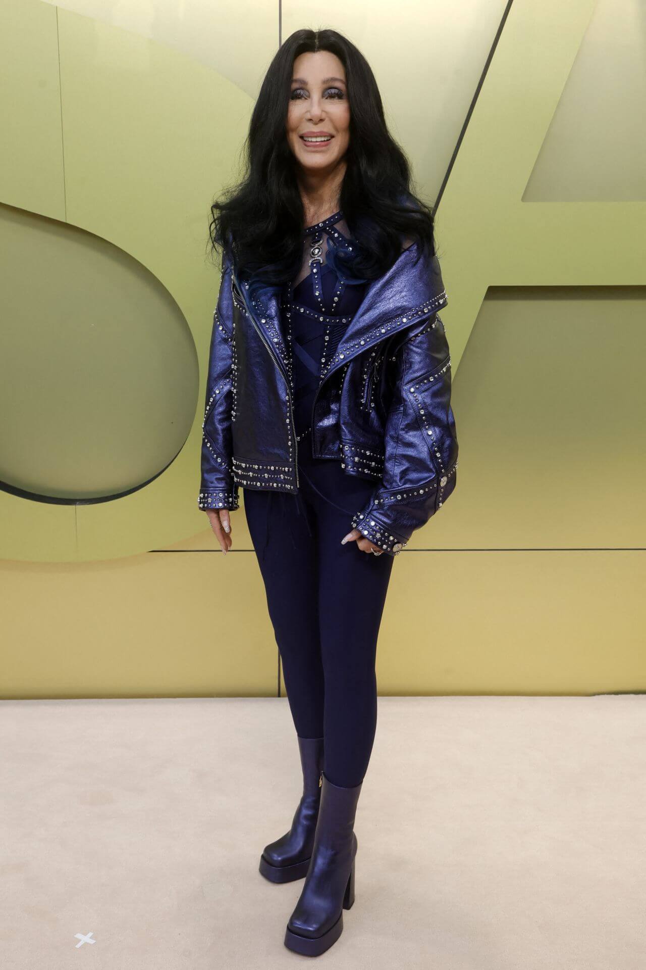 Cher In Blue Leather Shimmery Jacket Under Top With Jeggings At Versace Fashion Show in West Hollywood