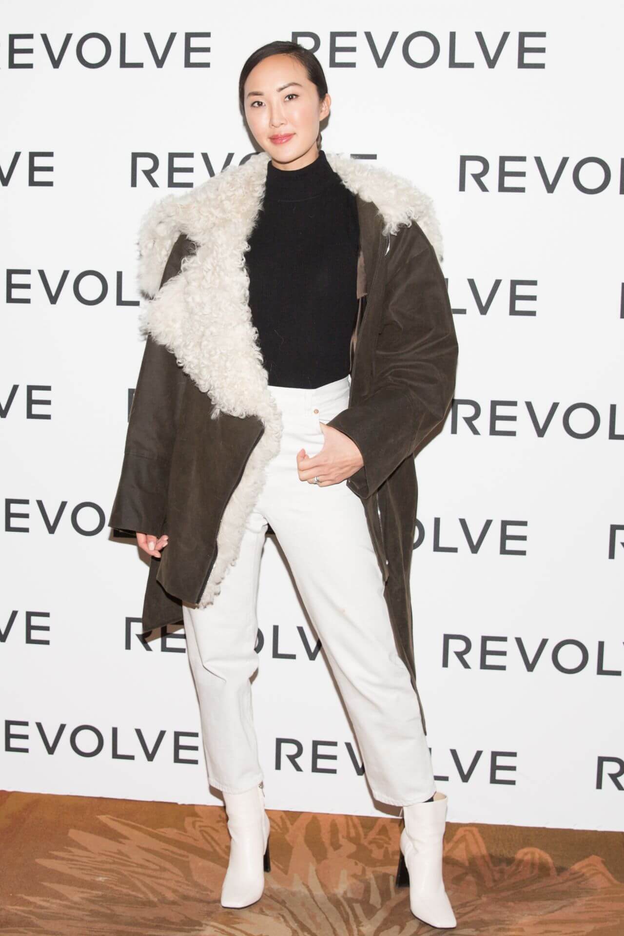 Chriselle Lim  In Fur Baggy Jacket Under Black Top With White Pants At Camila Coelho’s 30th Birthday Party in Paris