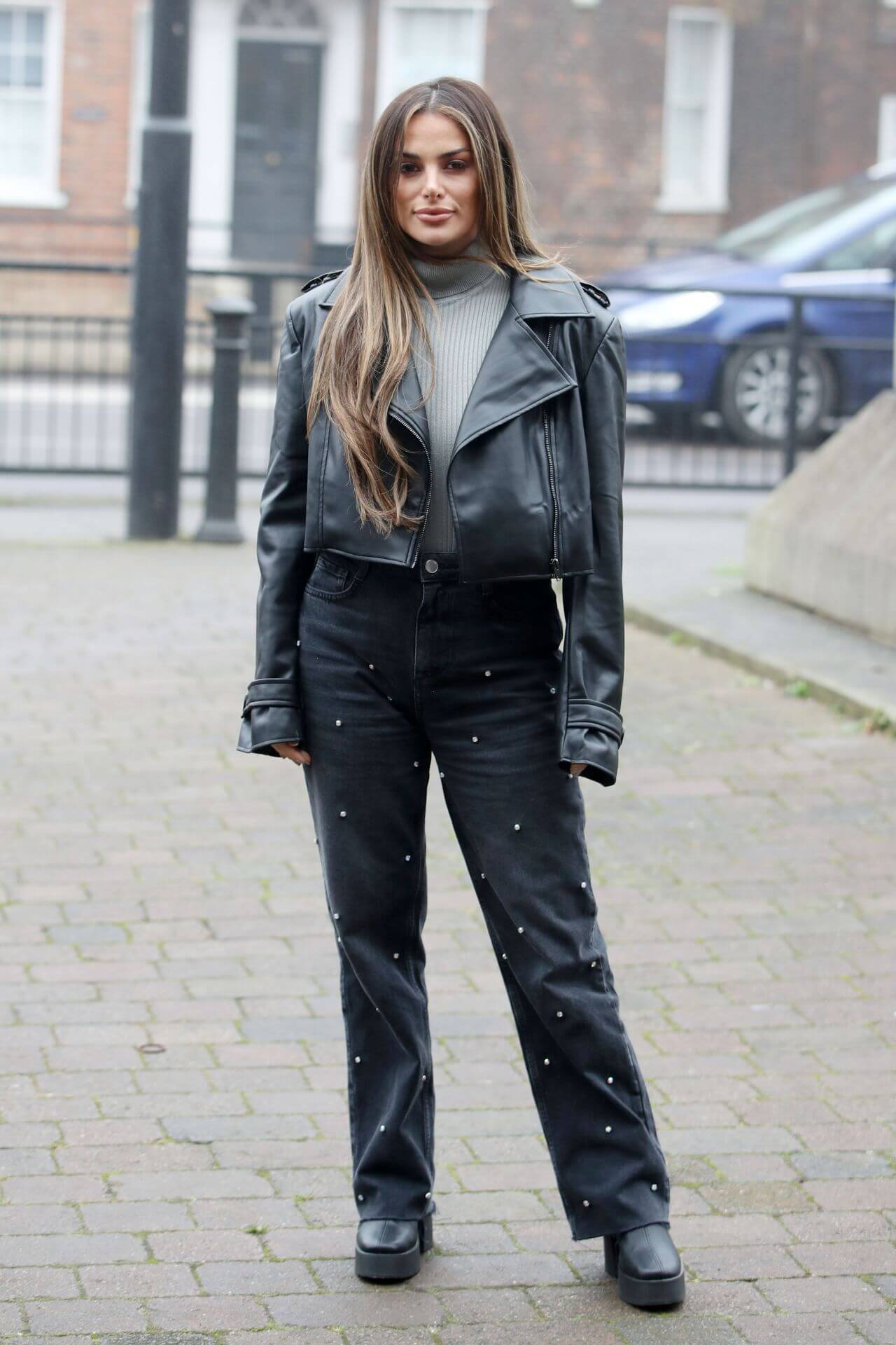 Courtney Green  In Grey Leather Jacket Under High Neck Top With Black Flare Pants At  Filming “TOWIE” in Essex