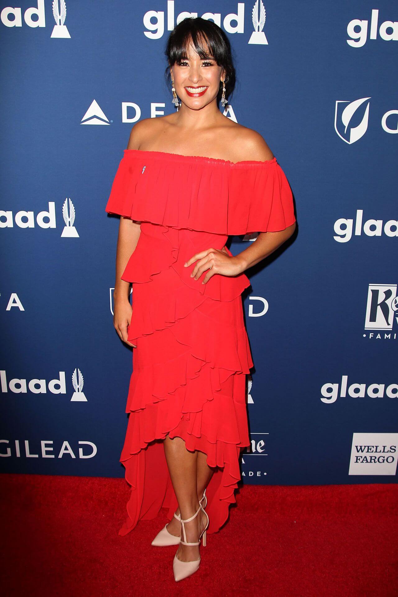 Courtney Reed  In Red Off Shoulder Long Ruffle Dress At GLAAD Media Awards
