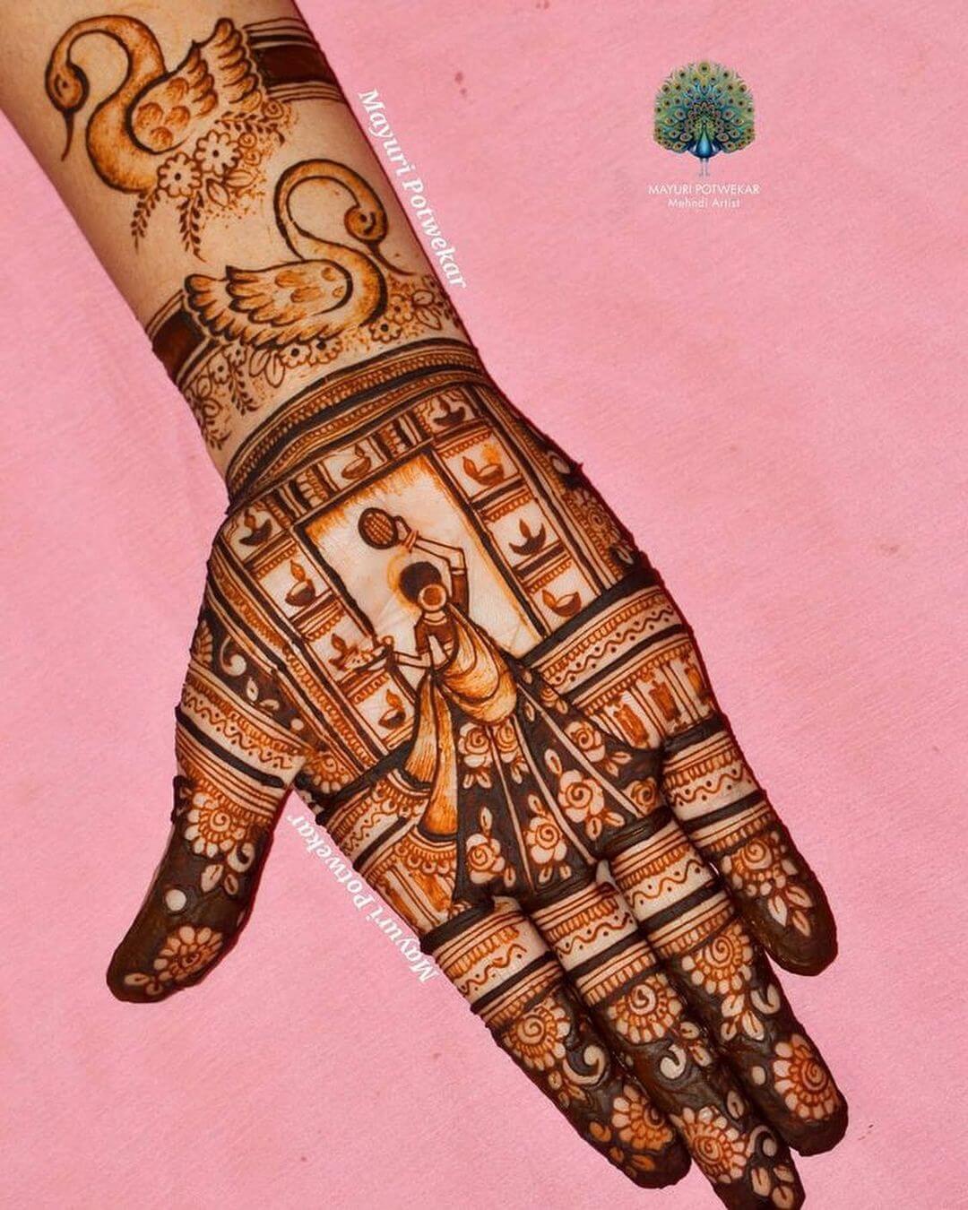 A Decorative Diya With Swan Mehndi Design