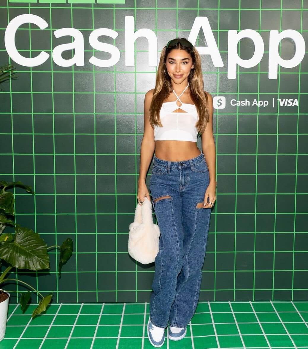 Chantel Jeffries In White Crop Top With Blue Ripped Jeans