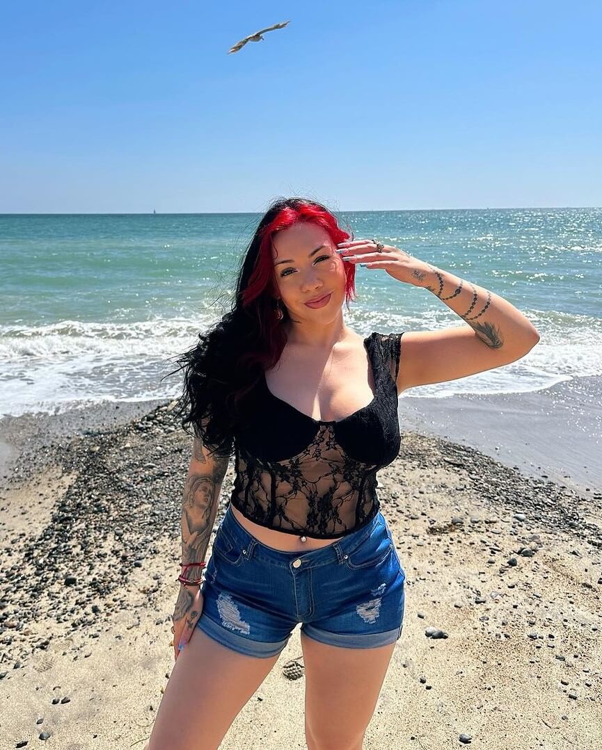 Salice Rose In a Black Crop Top With Denim Shorts