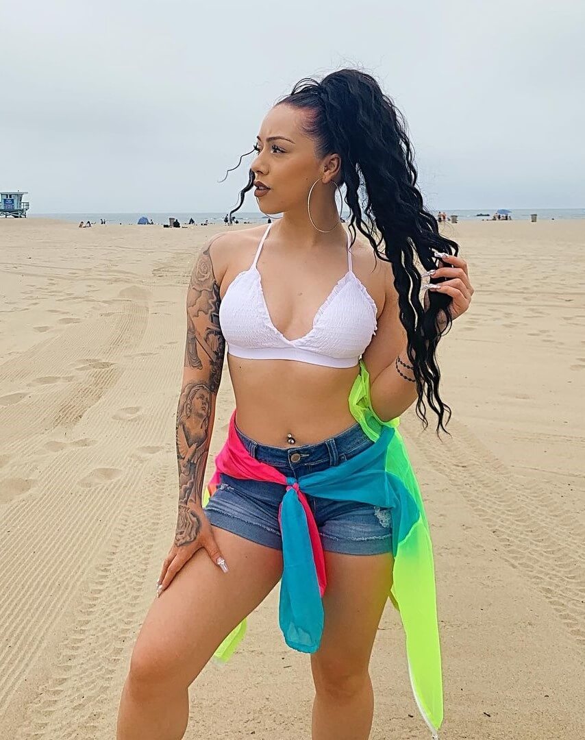 Salice Rose In a White Bralette Top With Denim Shorts