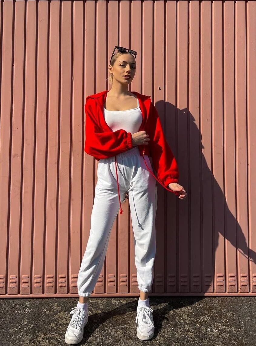 Tina Neumann In White Top And Jogger With Red Jacket