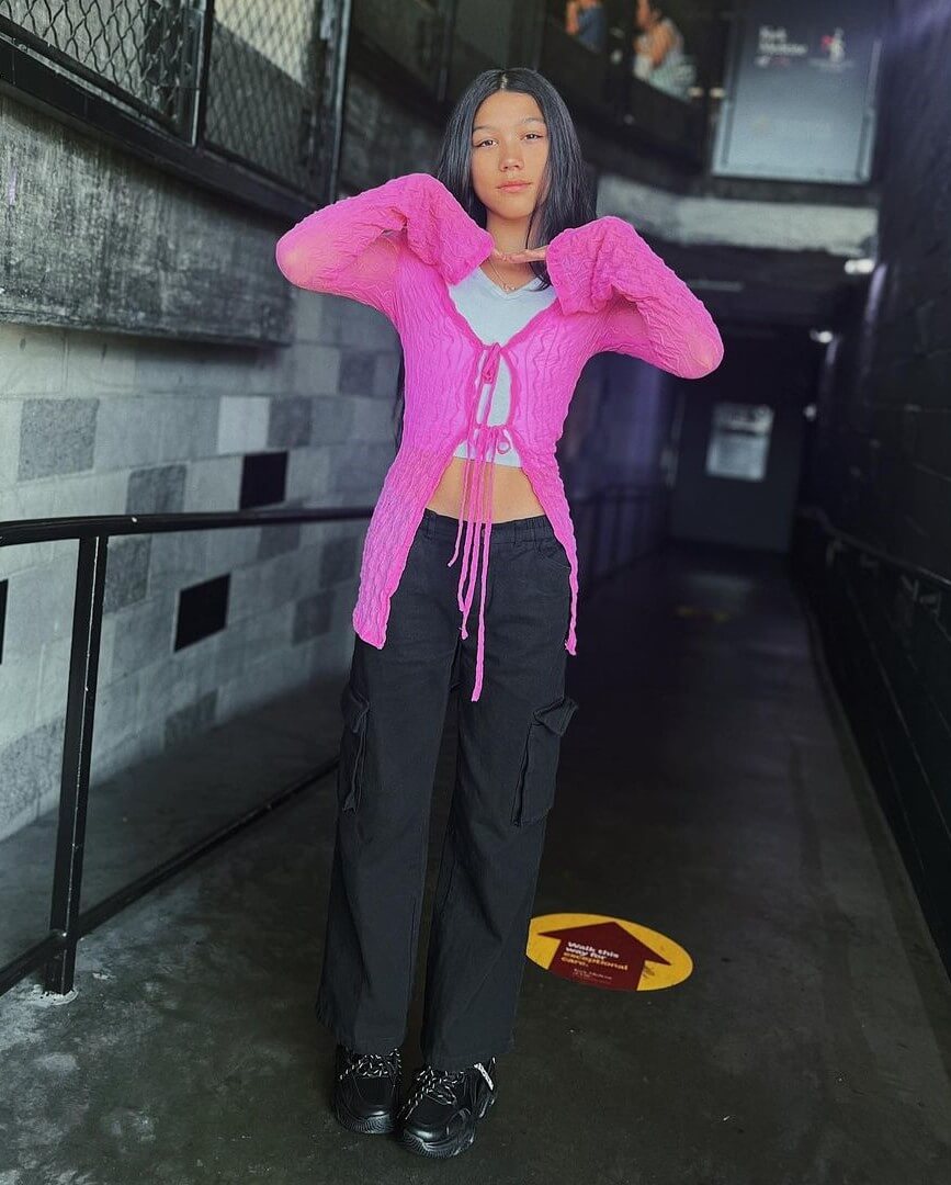 Txunamy  In a White Crop Top And Cargo Pants With a Pink Shrug