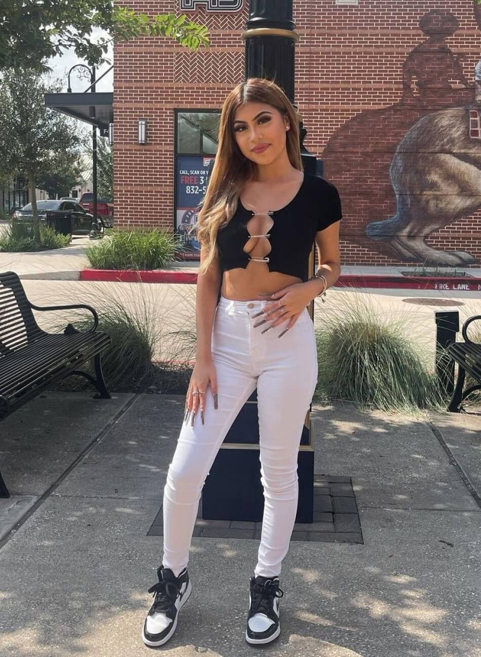 Desiree Montoya In a Black Crop Top With White Jeans
